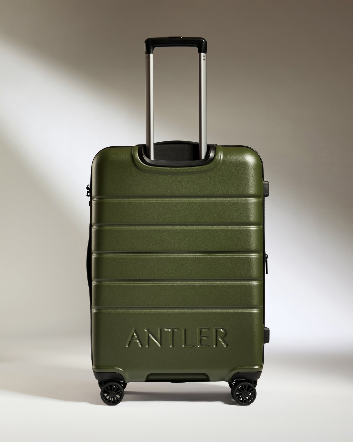 a green suitcase with handle