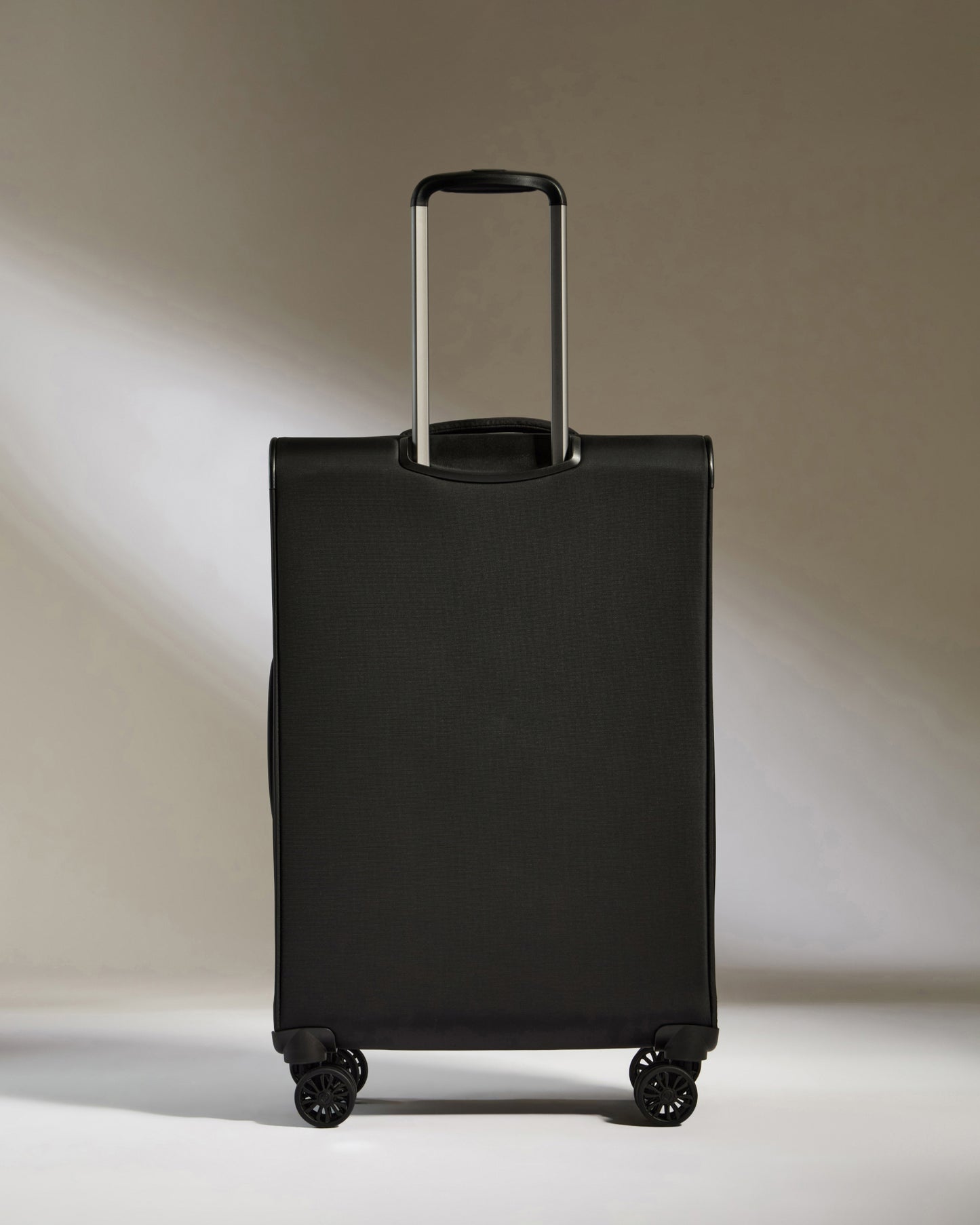Lightest Medium Luggage in Black - Soft Stripe