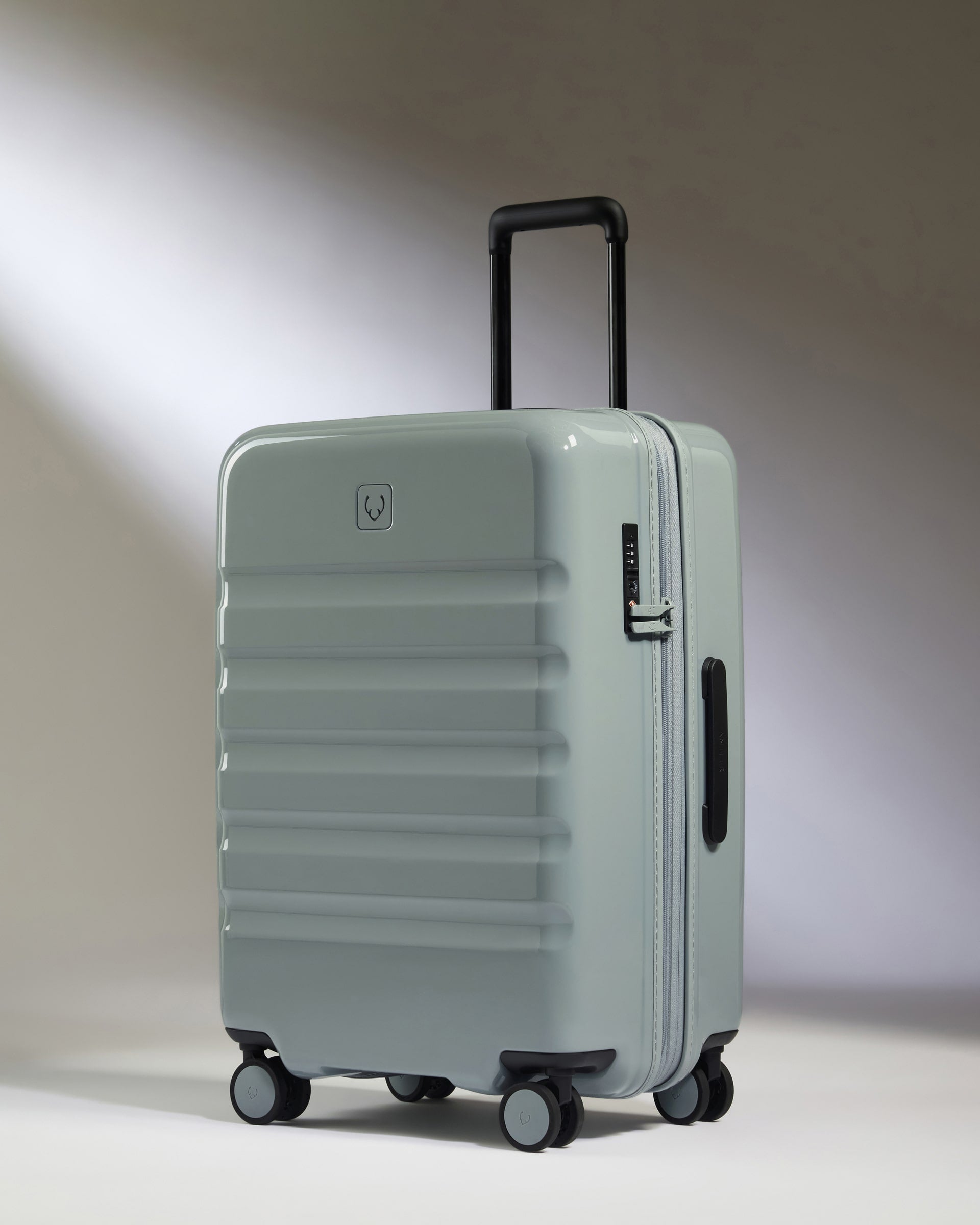 a grey suitcase with wheels