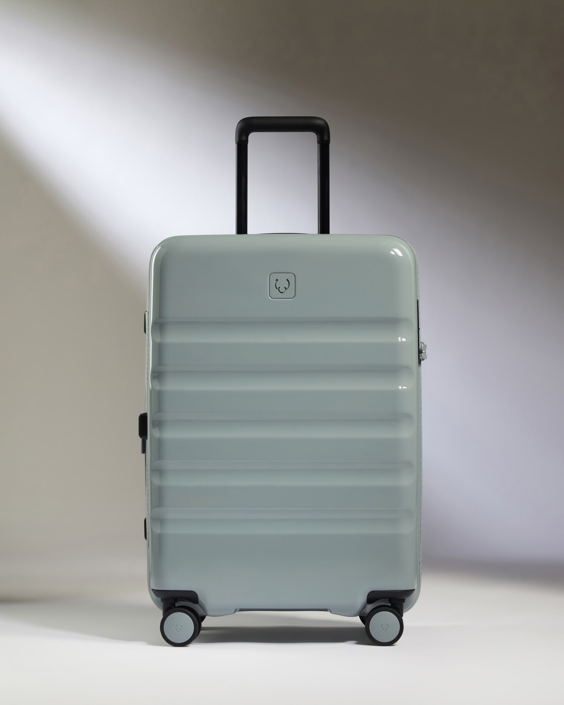 a grey suitcase with wheels