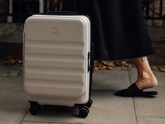 a person standing next to a suitcase