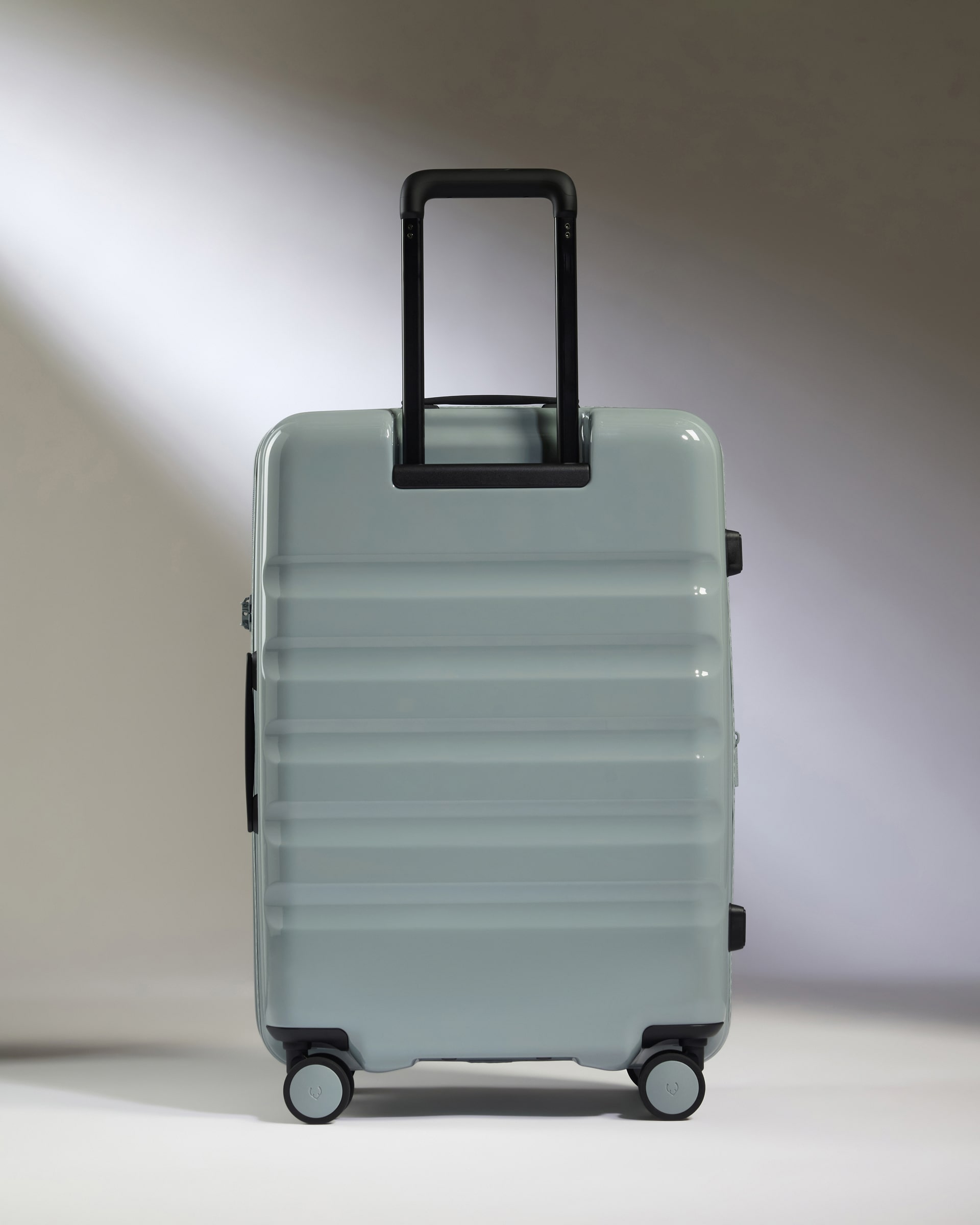 a grey suitcase with black handle