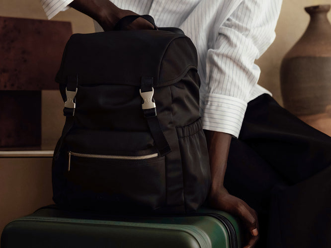 a person sitting on a suitcase