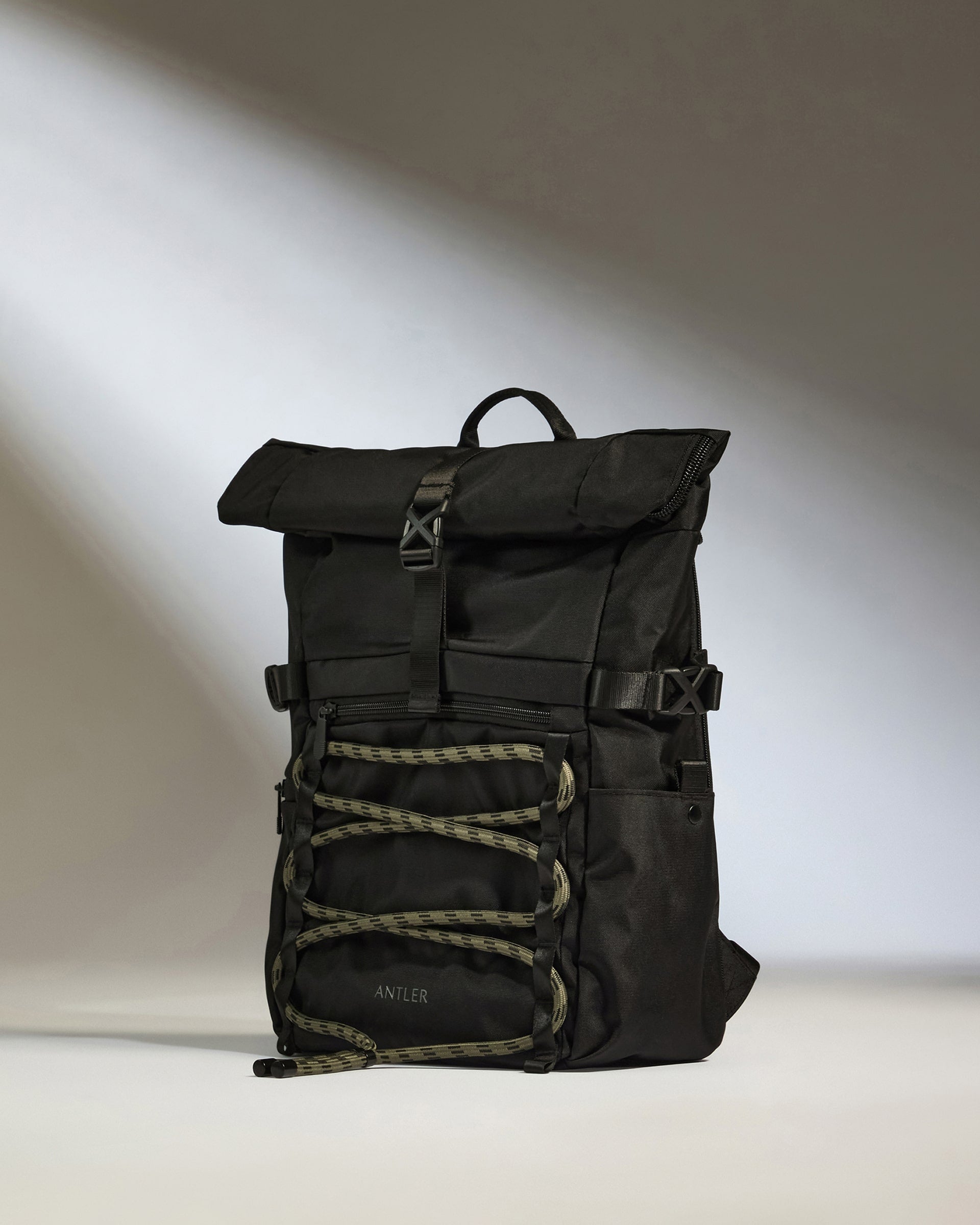 a black backpack with green straps