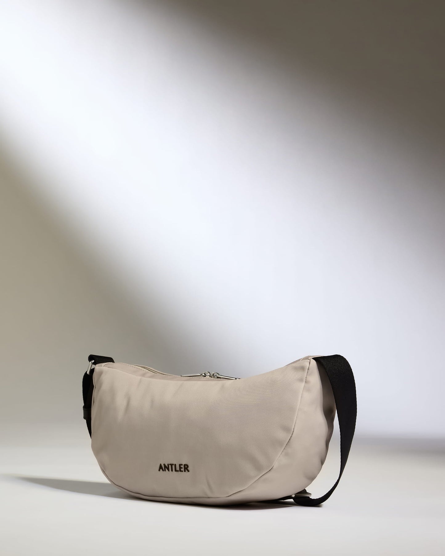 a tan bag with a black strap