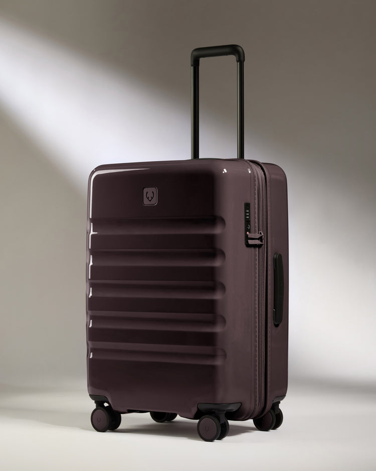 a purple suitcase with wheels