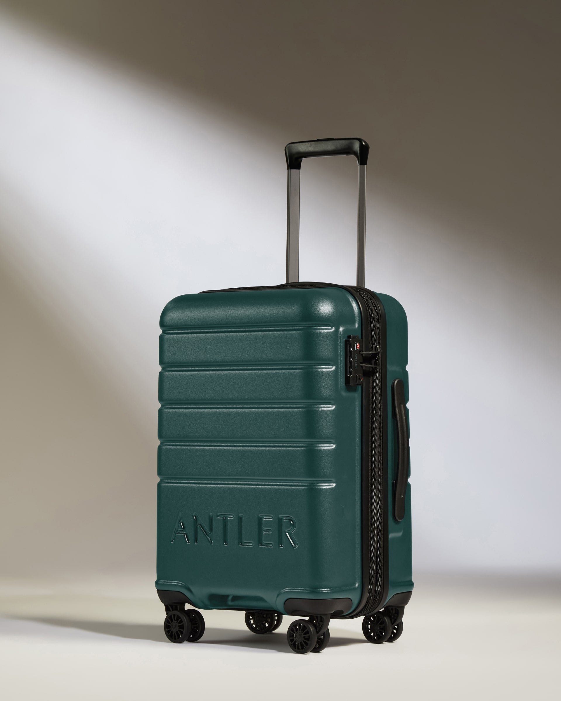 a green suitcase with wheels