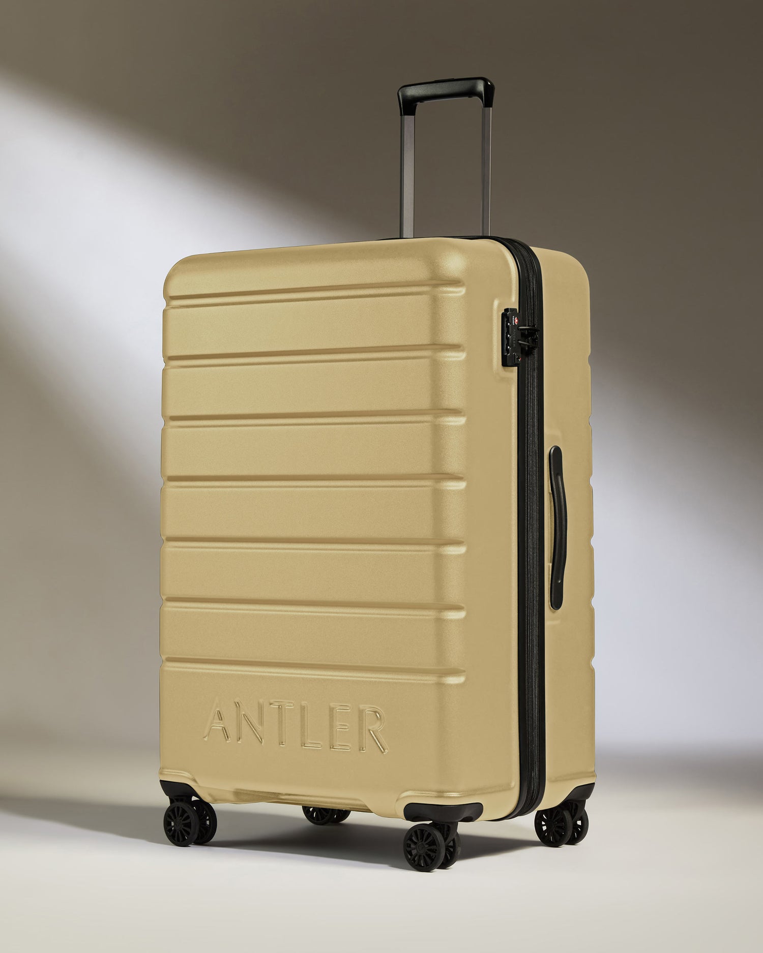 Large Luggage in Dark Sand - Logo