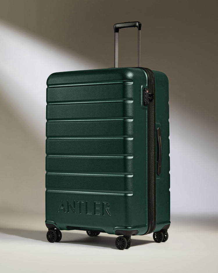 a green suitcase with wheels