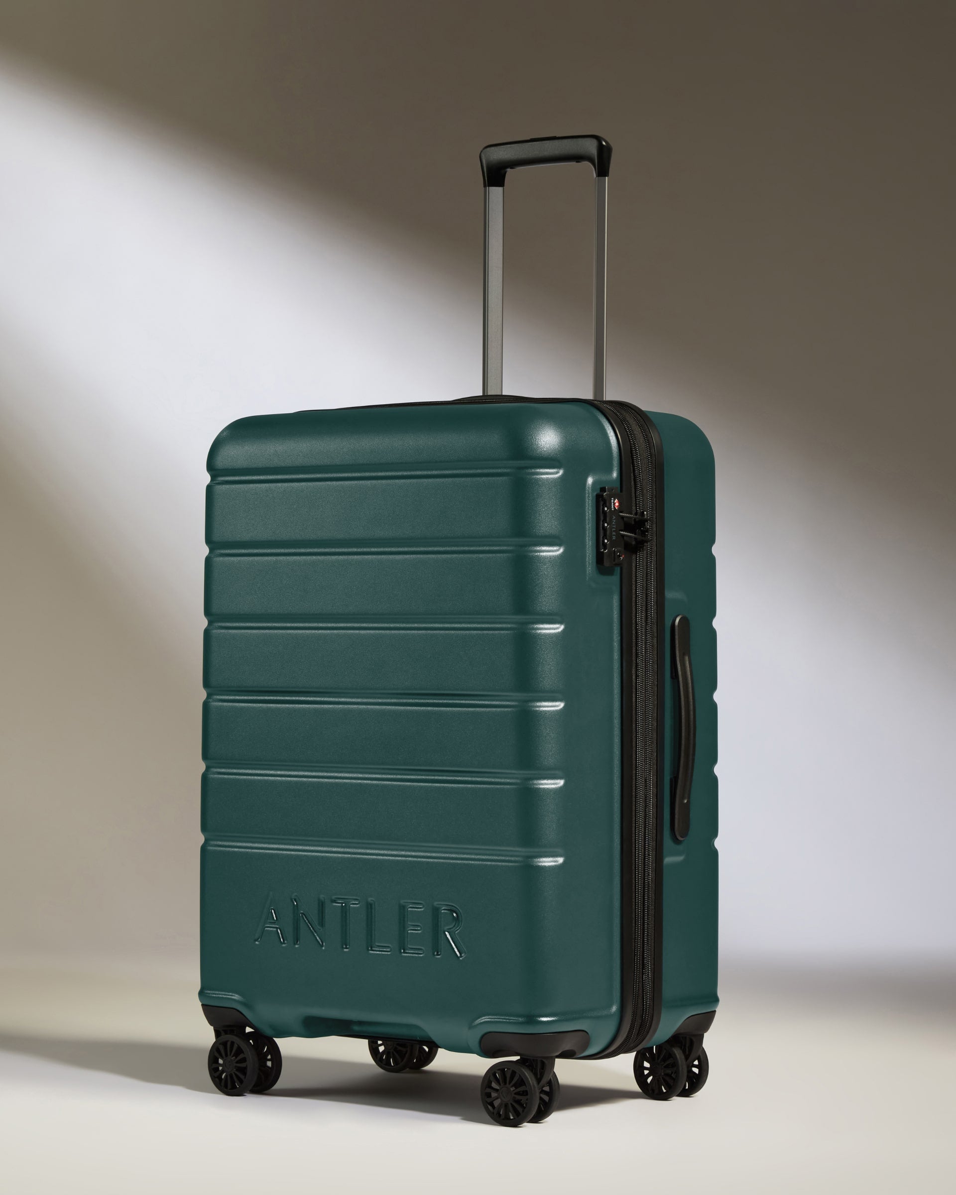 a green suitcase with wheels