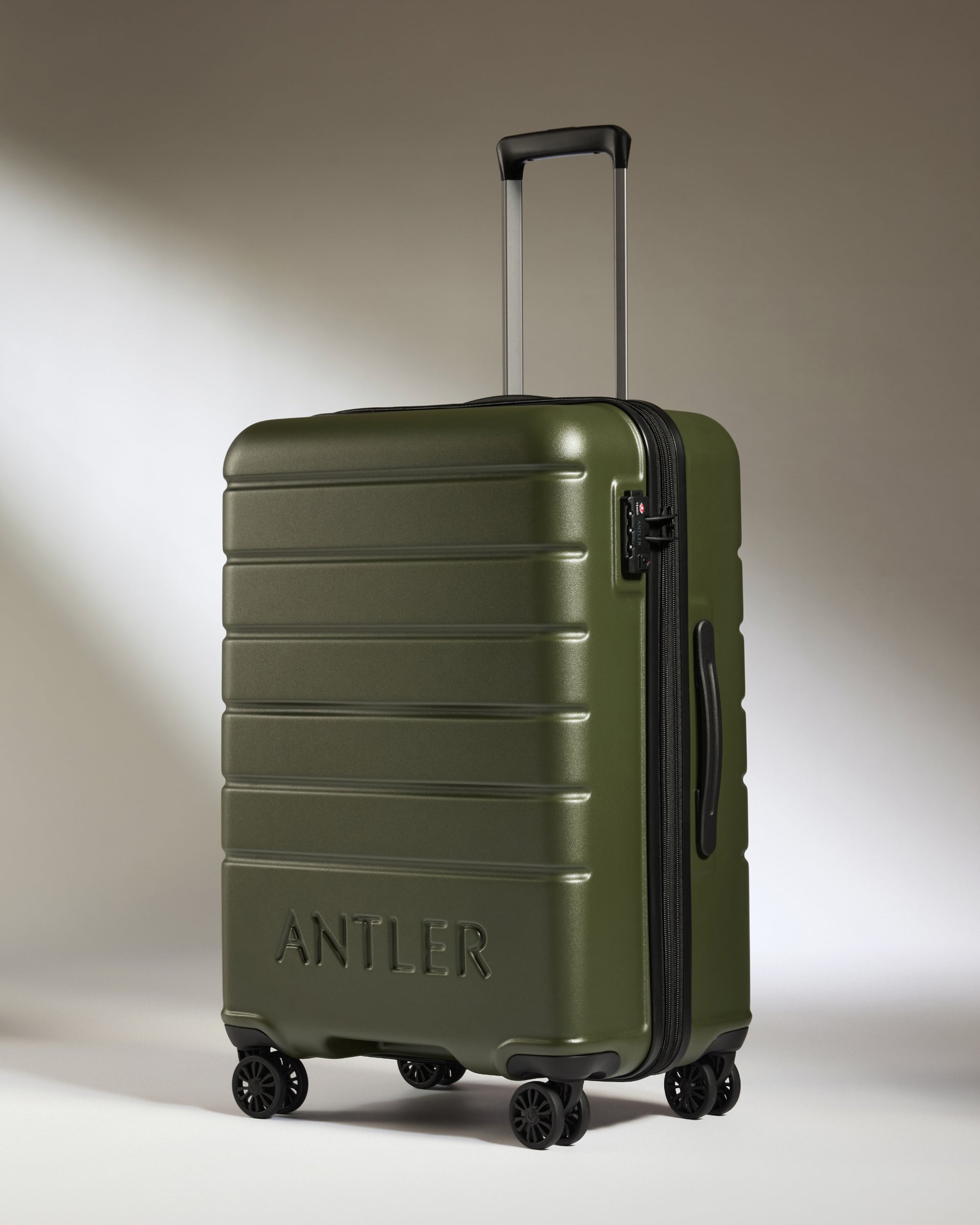 a green suitcase with wheels