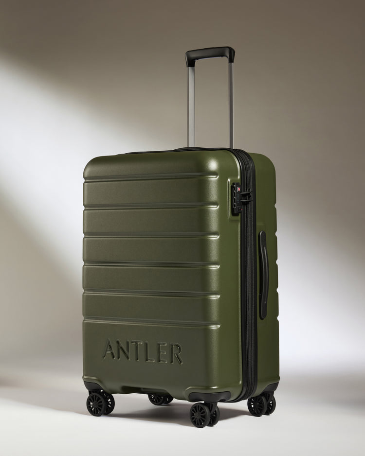 a green suitcase with wheels
