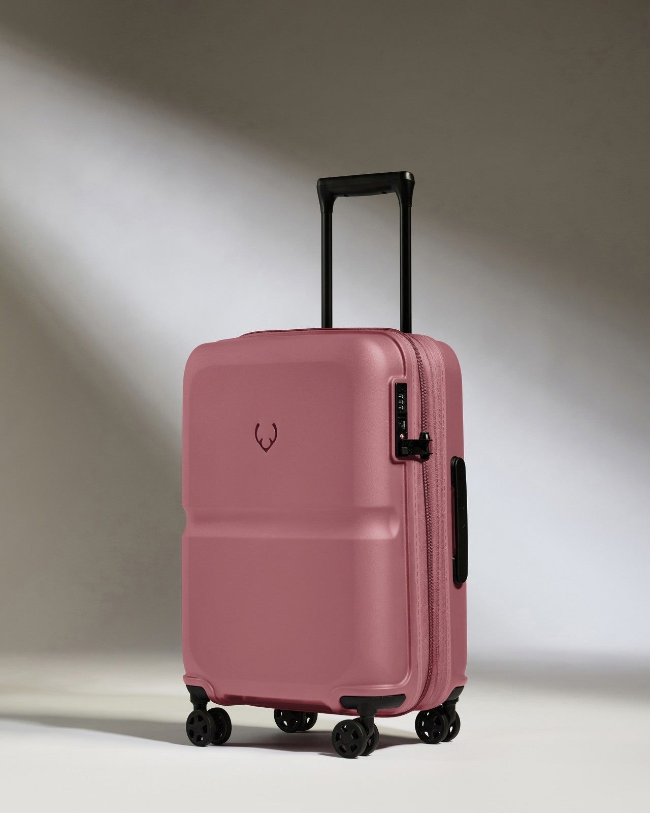 a pink suitcase with wheels