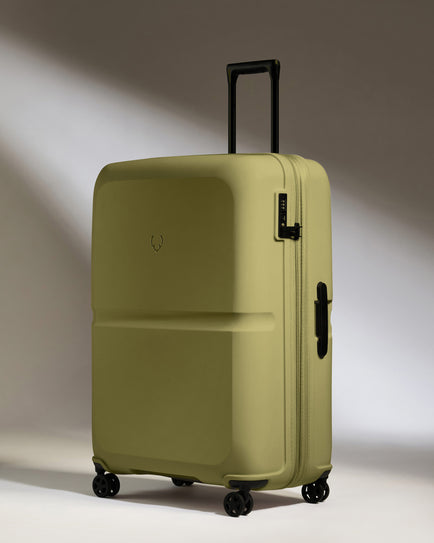 a green suitcase with wheels