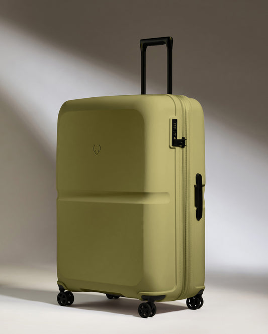 a green suitcase with wheels