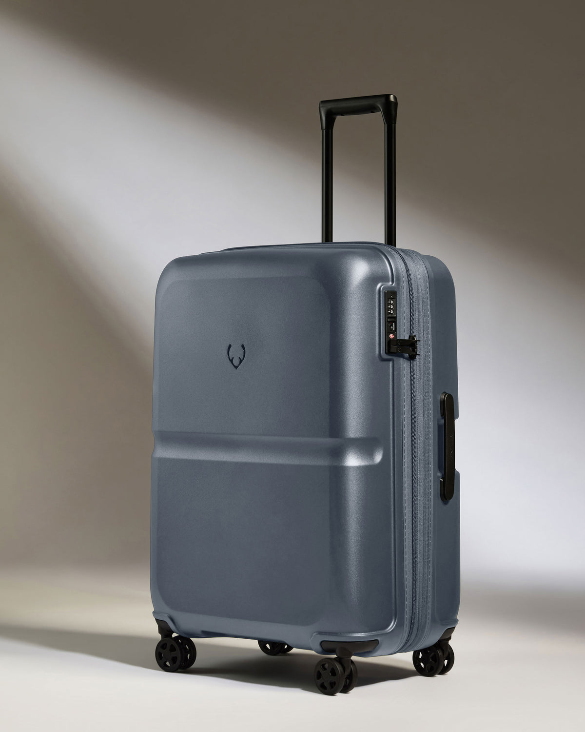 a suitcase on wheels with a light shining on it