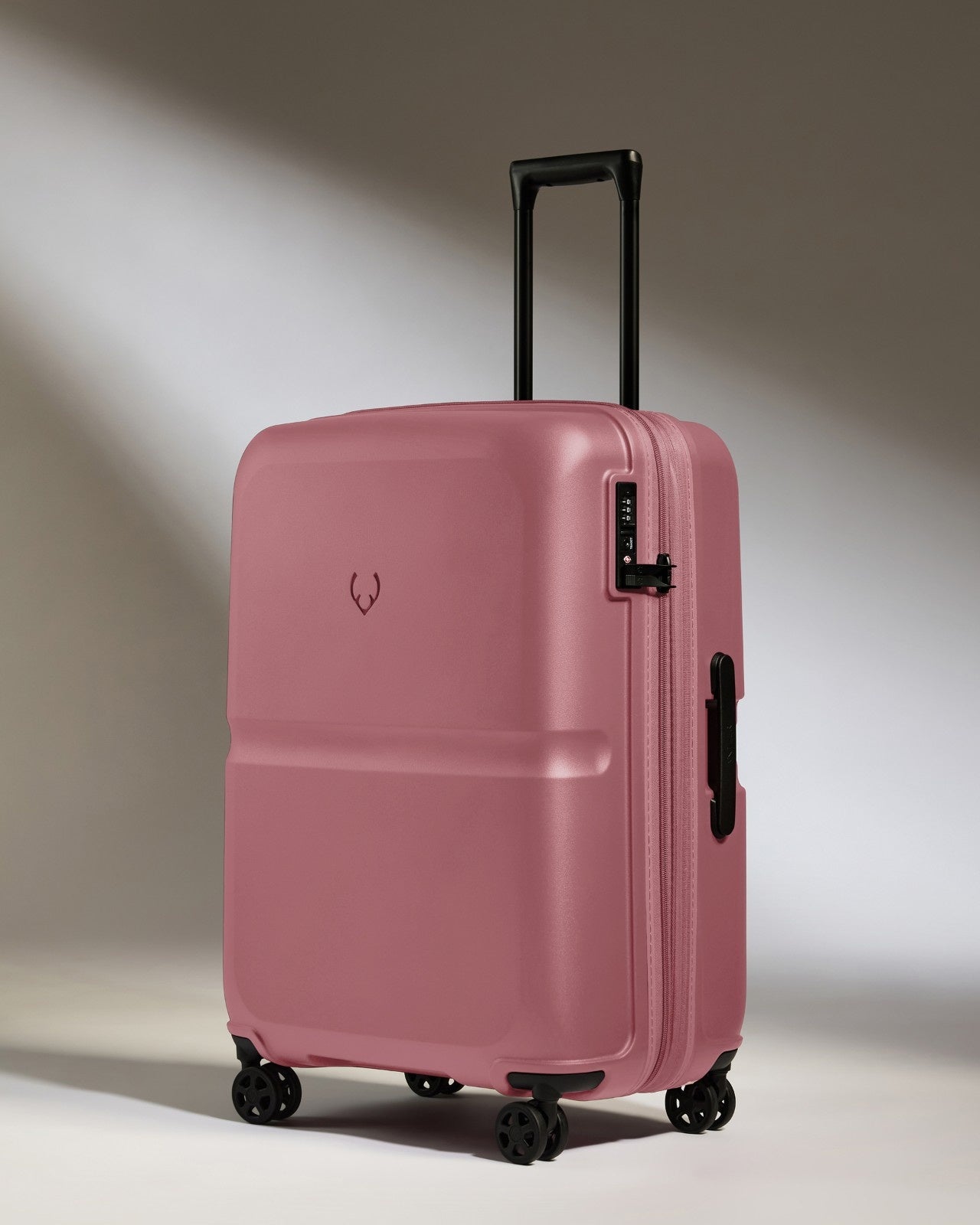 a pink suitcase with wheels