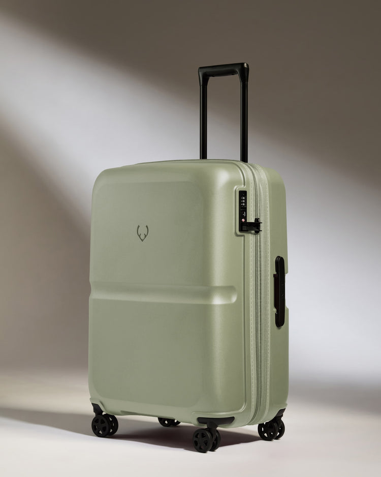 a green suitcase with wheels