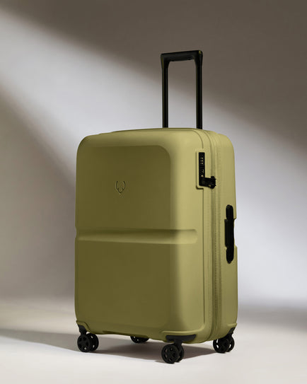 a green suitcase with wheels