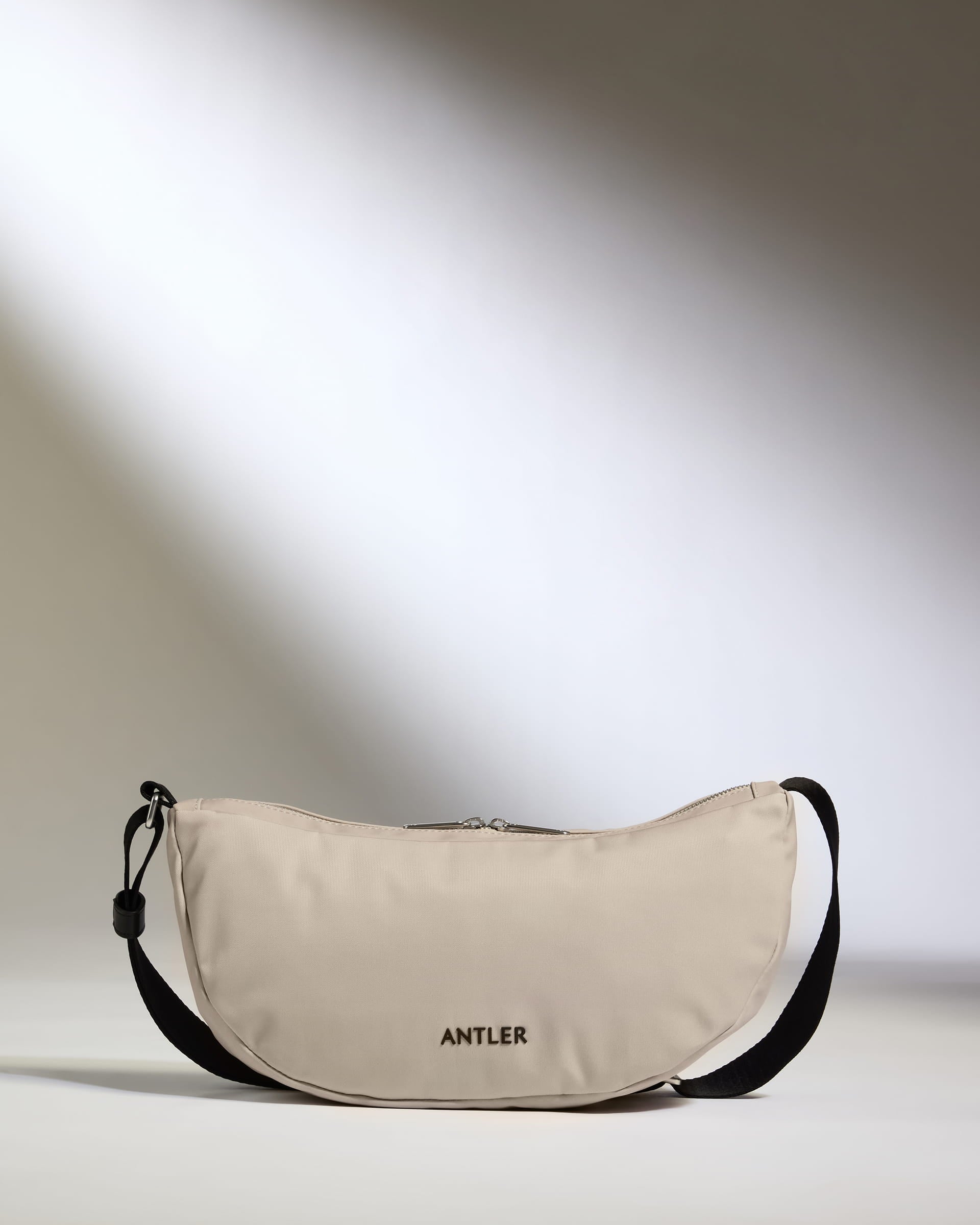 a tan bag with a black strap
