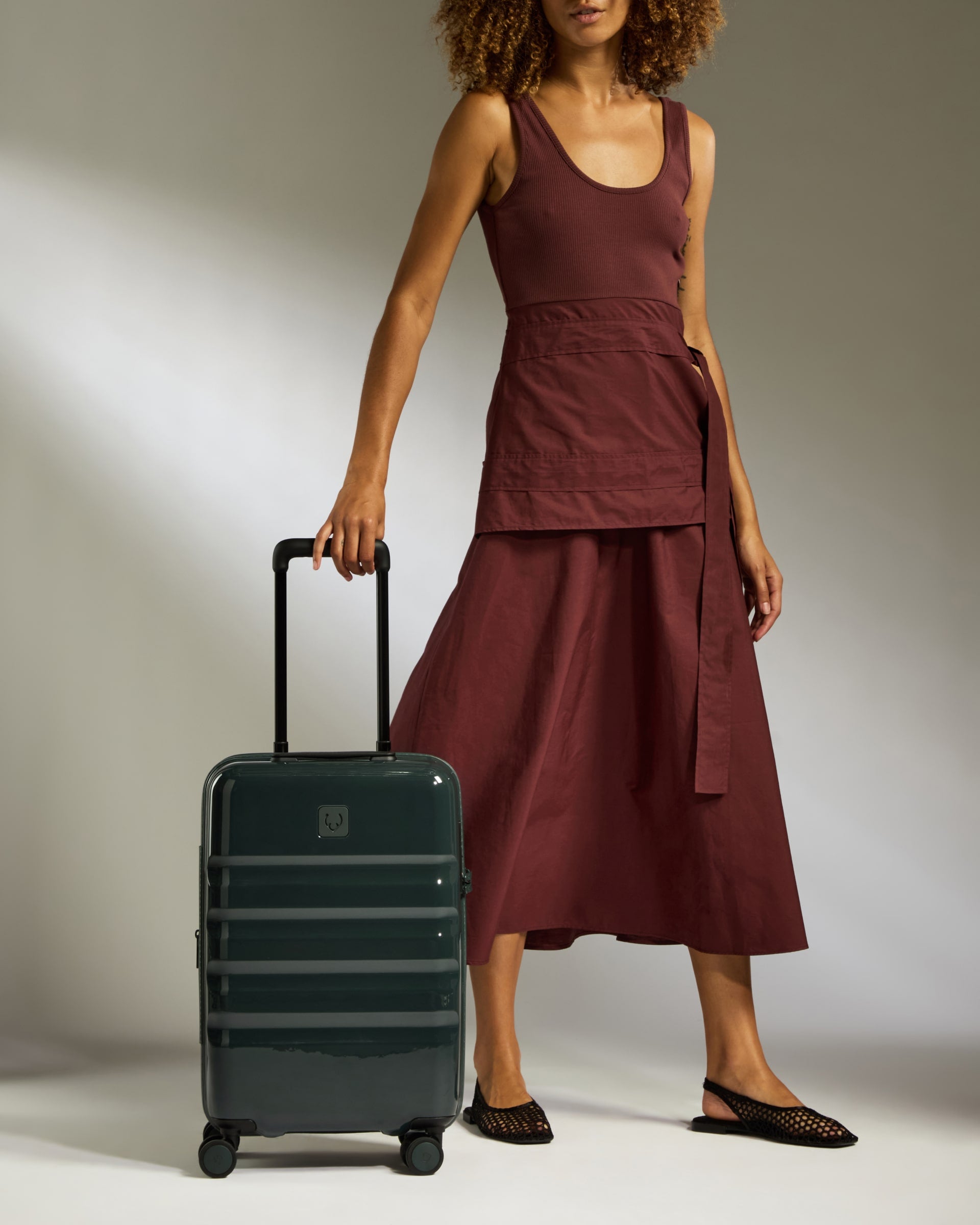a woman in a red dress and a suitcase