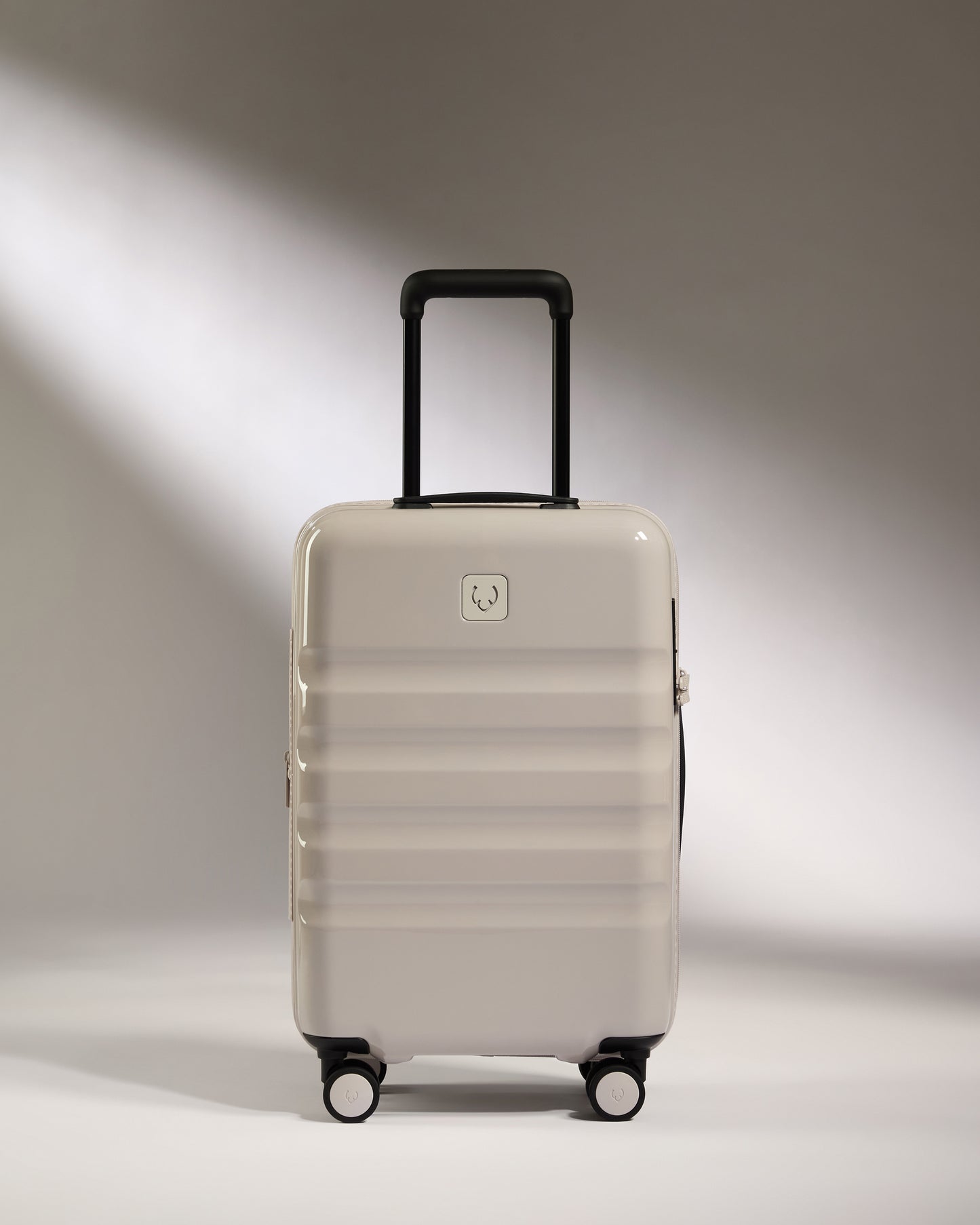 a white suitcase with black wheels