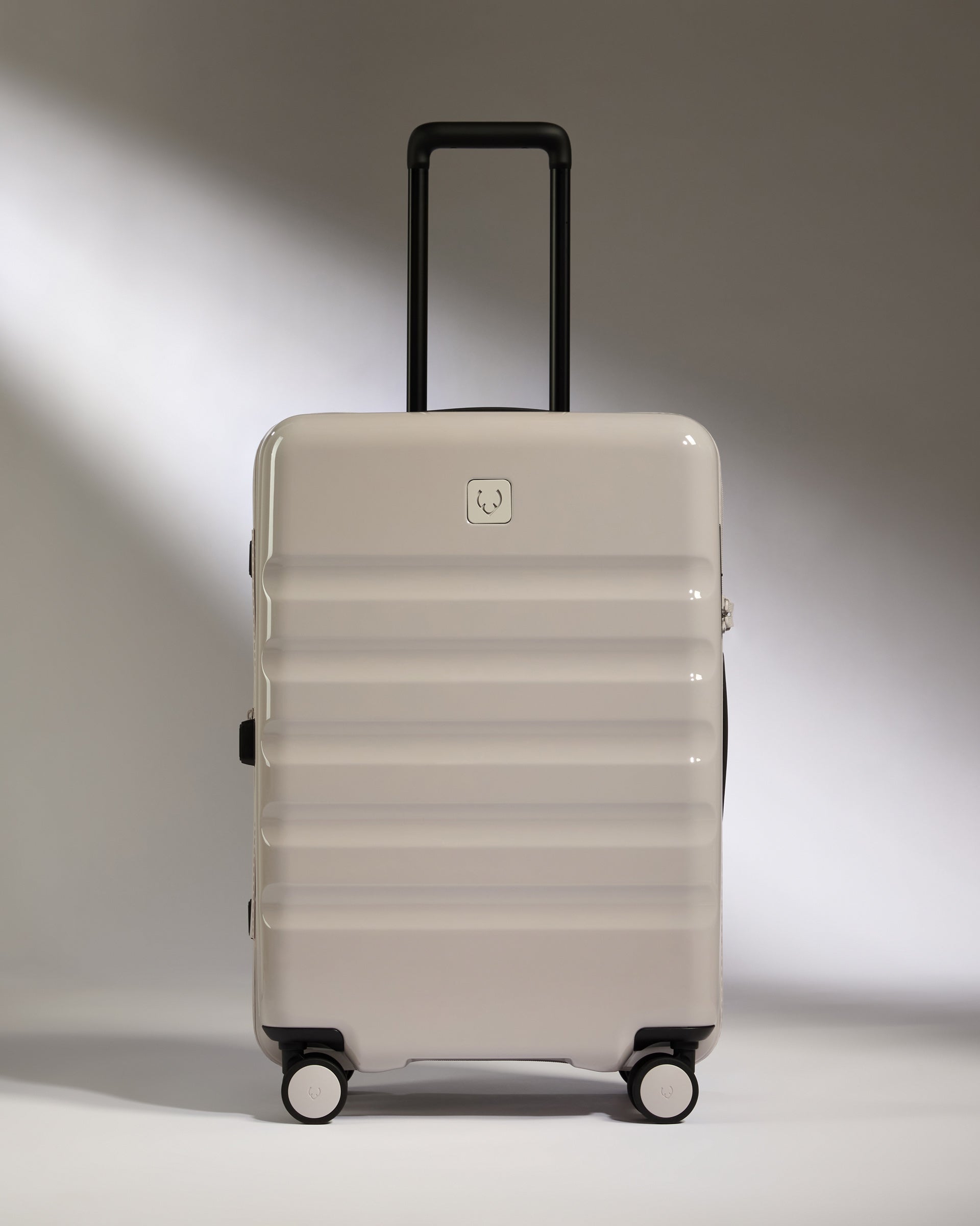a white suitcase with black wheels