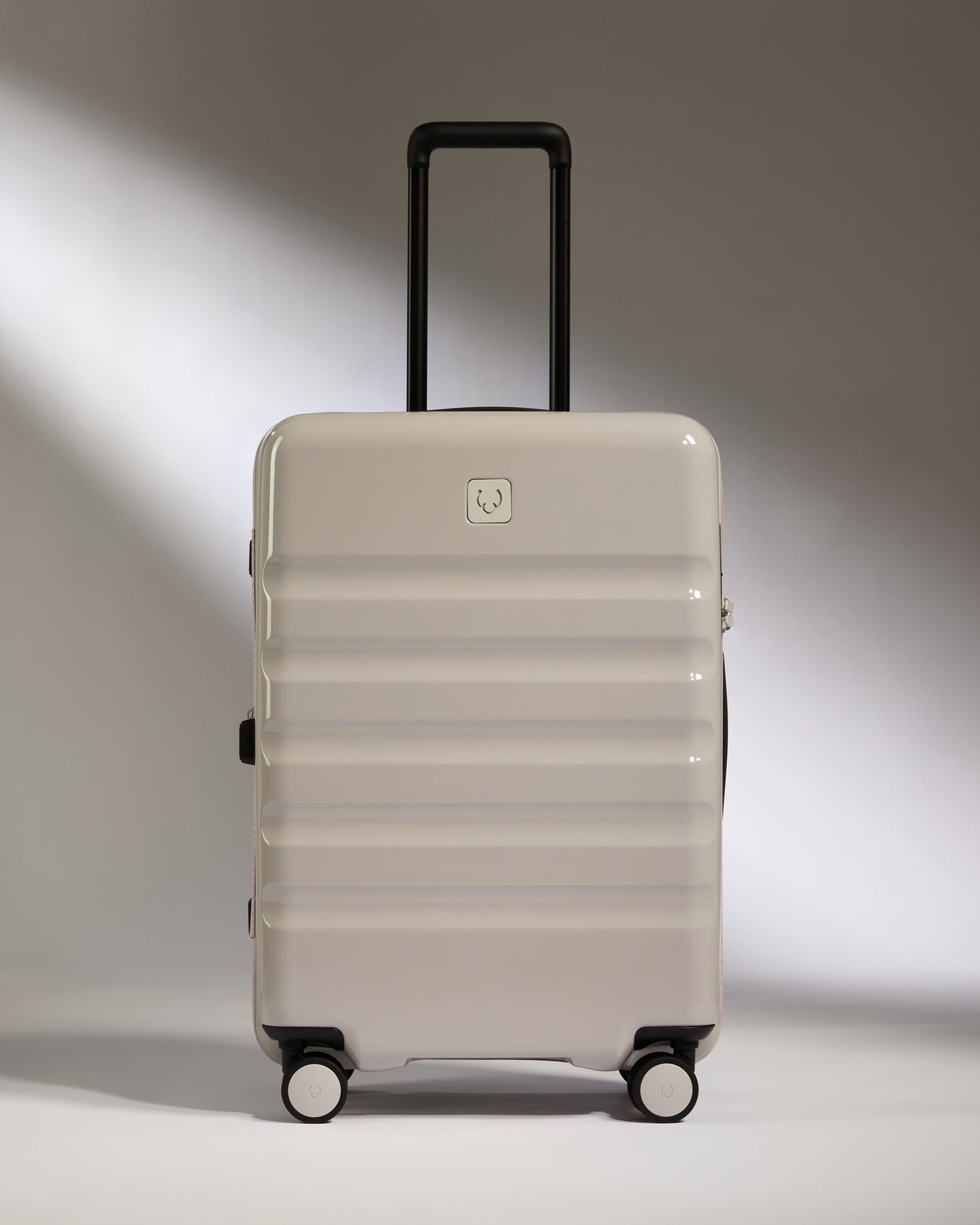 a white suitcase with black wheels