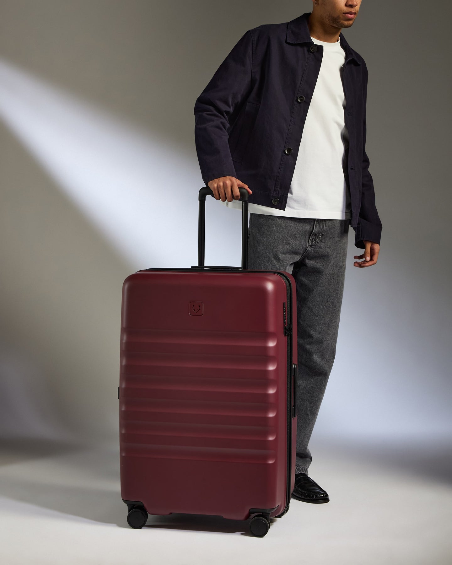 a man standing with a suitcase