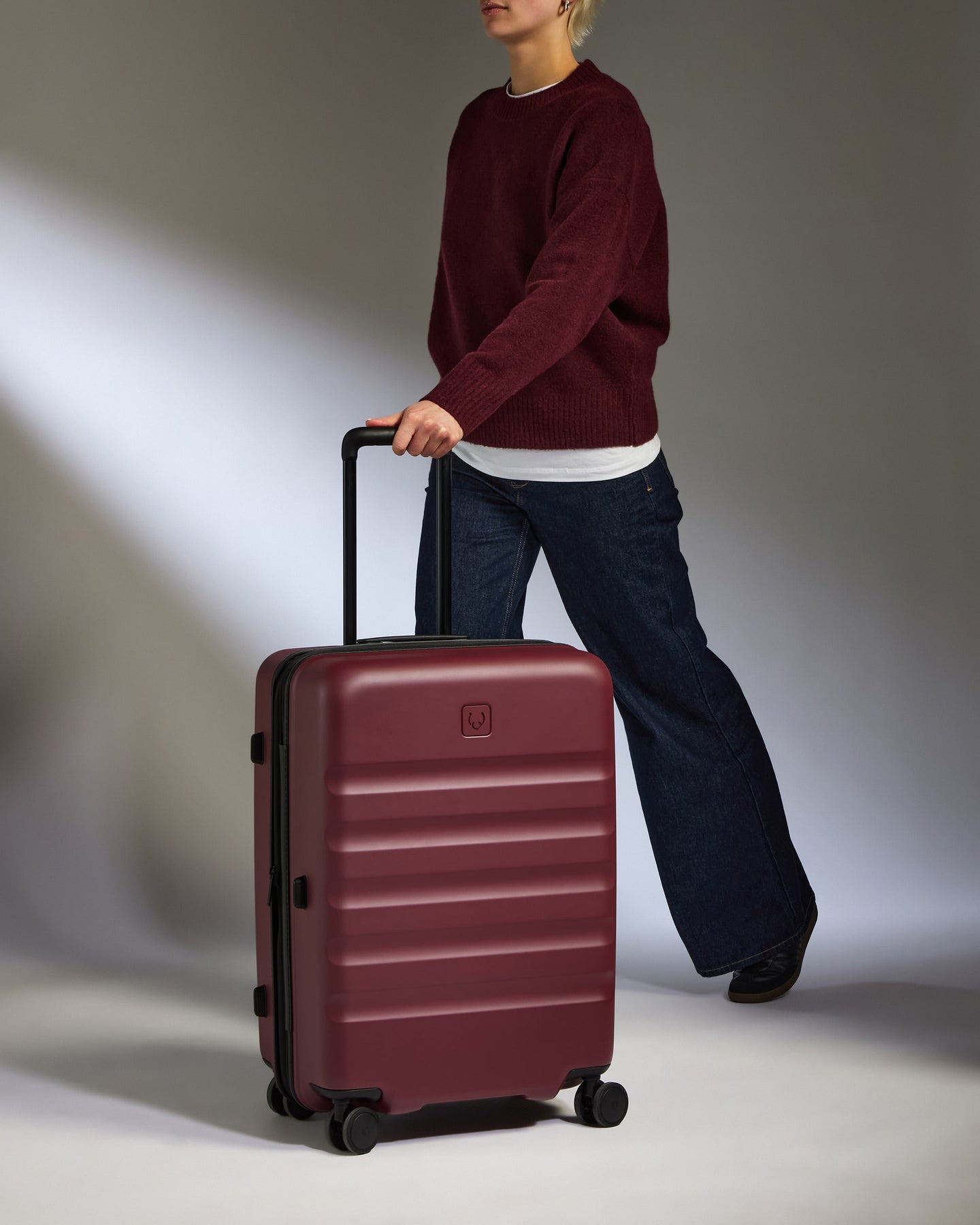 a man pulling a suitcase