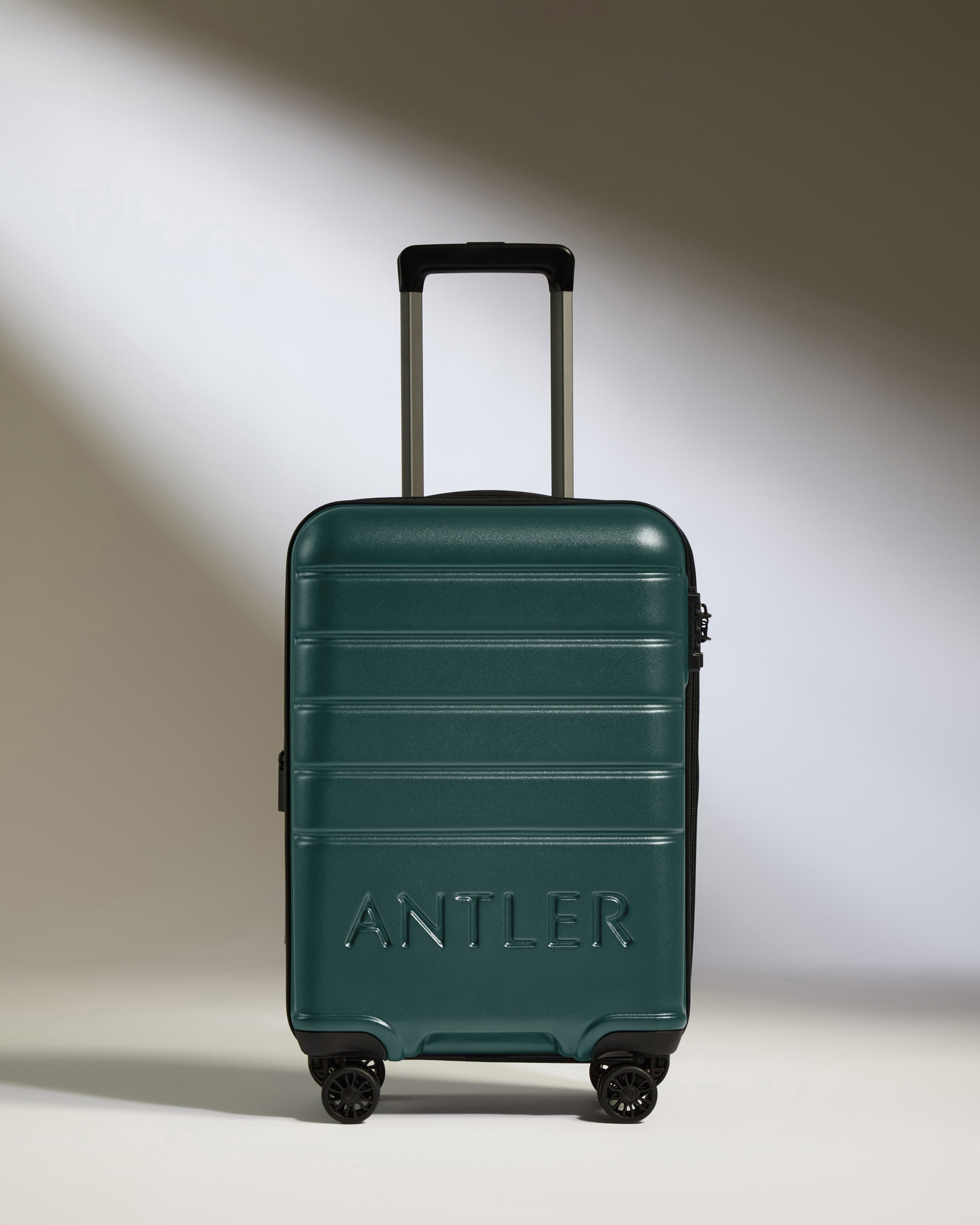 a green suitcase with wheels