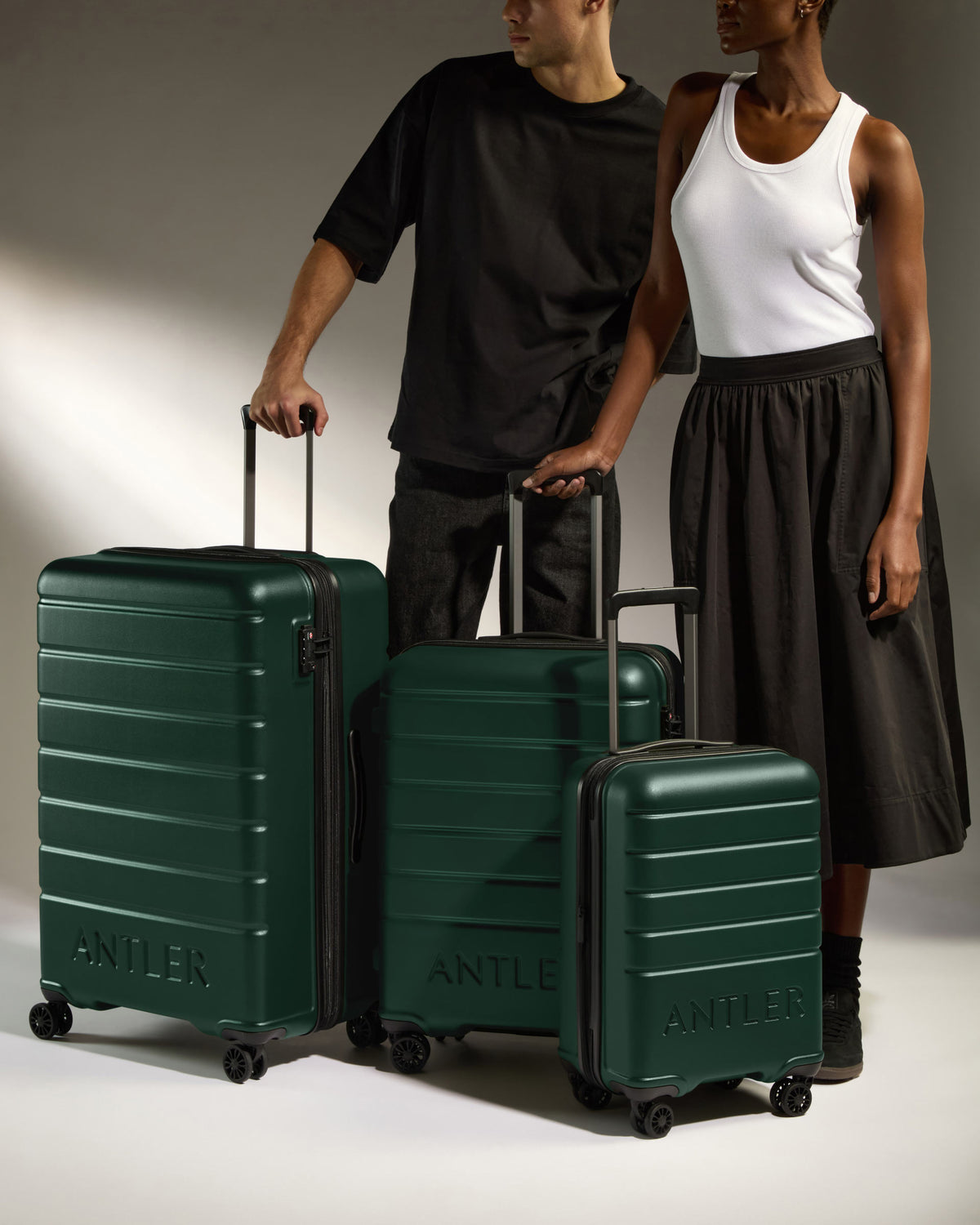 a man and woman standing next to luggage