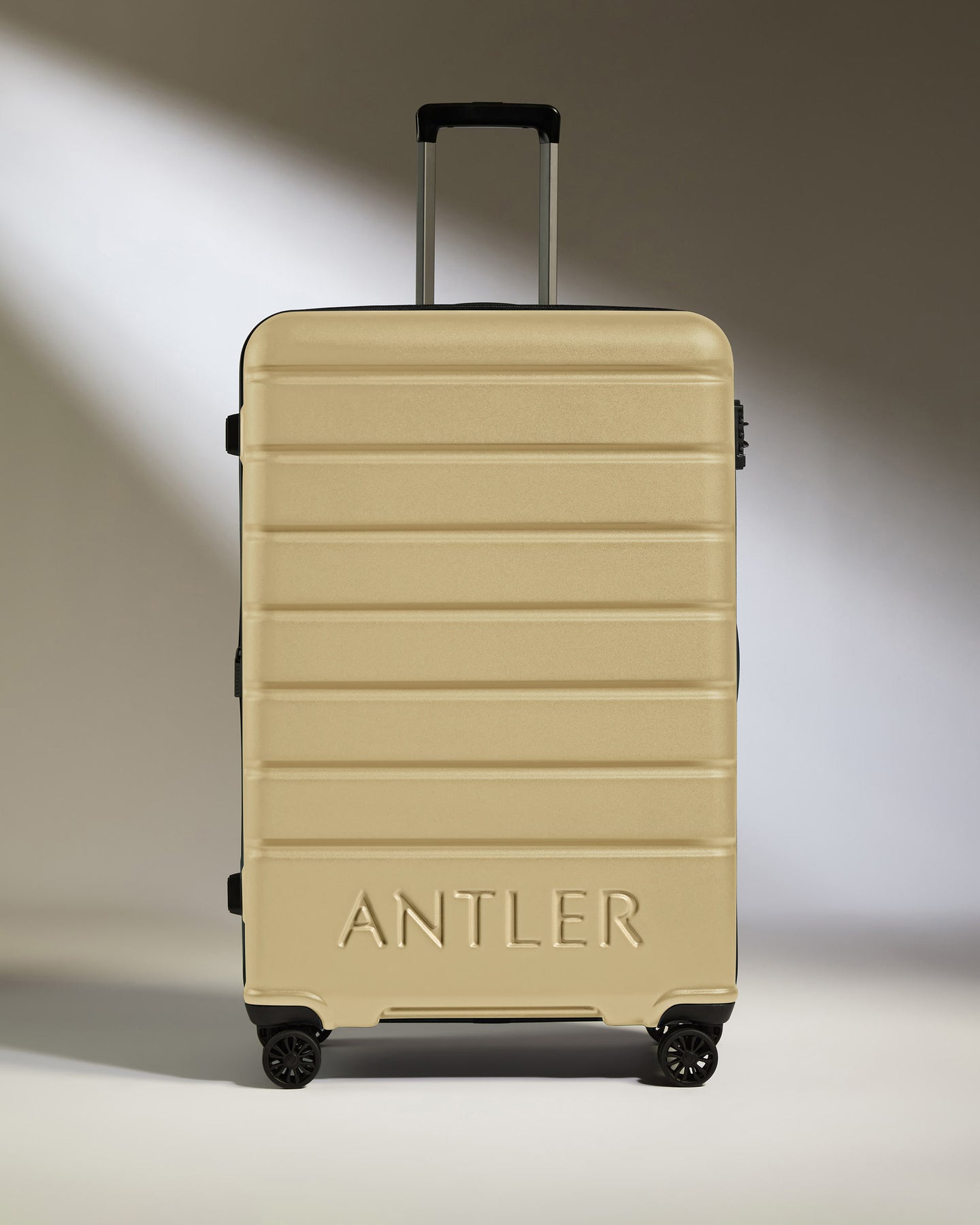 Large Luggage in Dark Sand - Logo