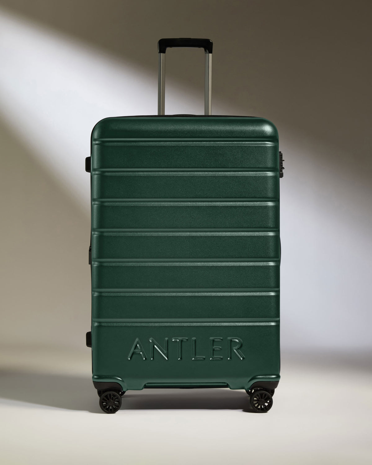 a green suitcase with wheels