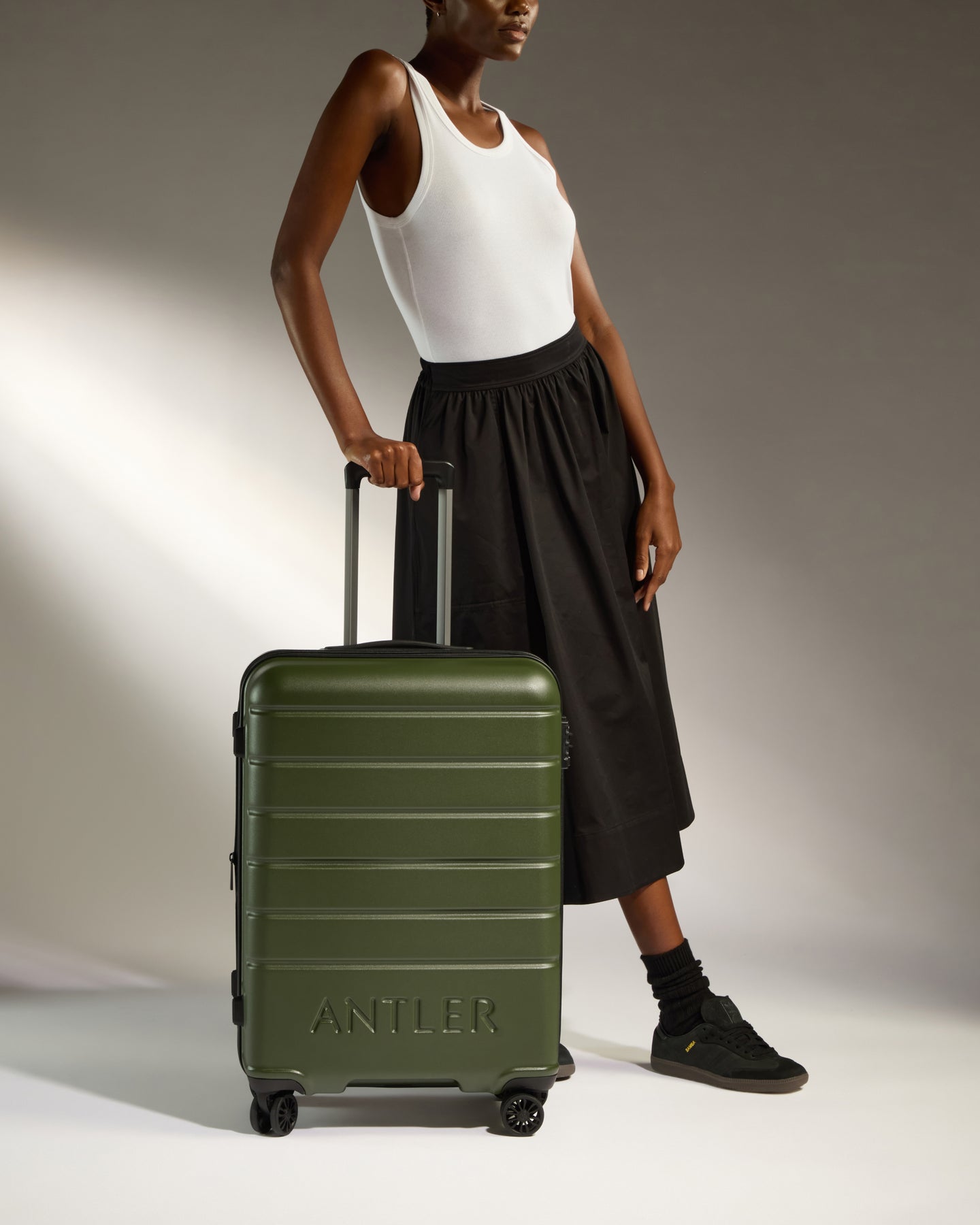 a woman standing next to a suitcase