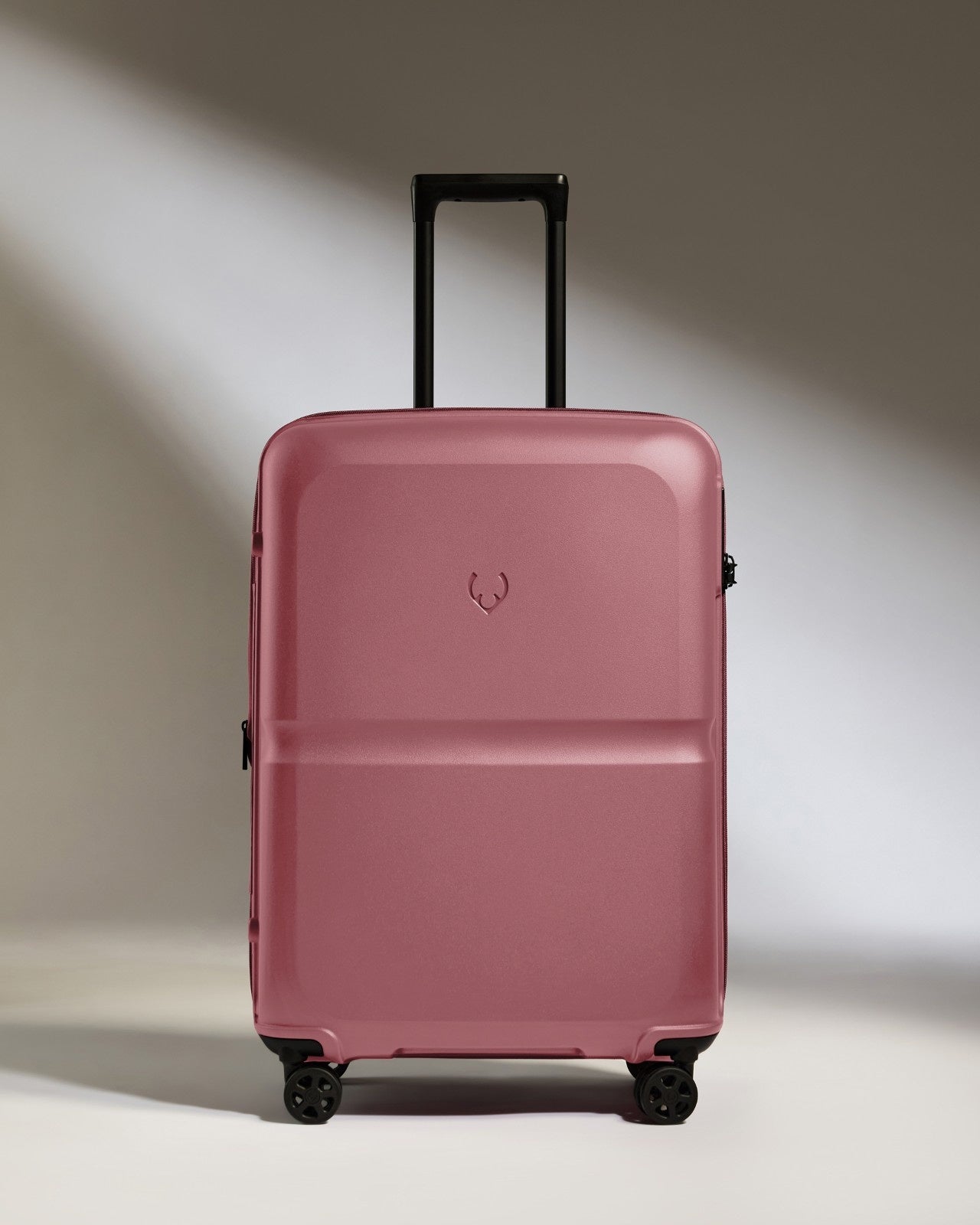 a pink suitcase with wheels