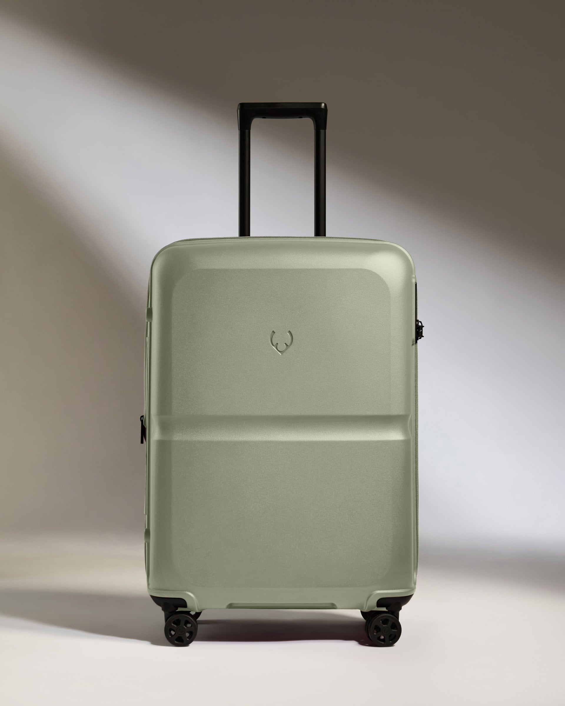 a grey suitcase with black wheels