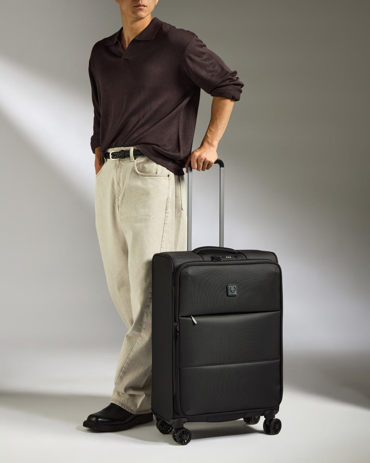 a man standing with a suitcase