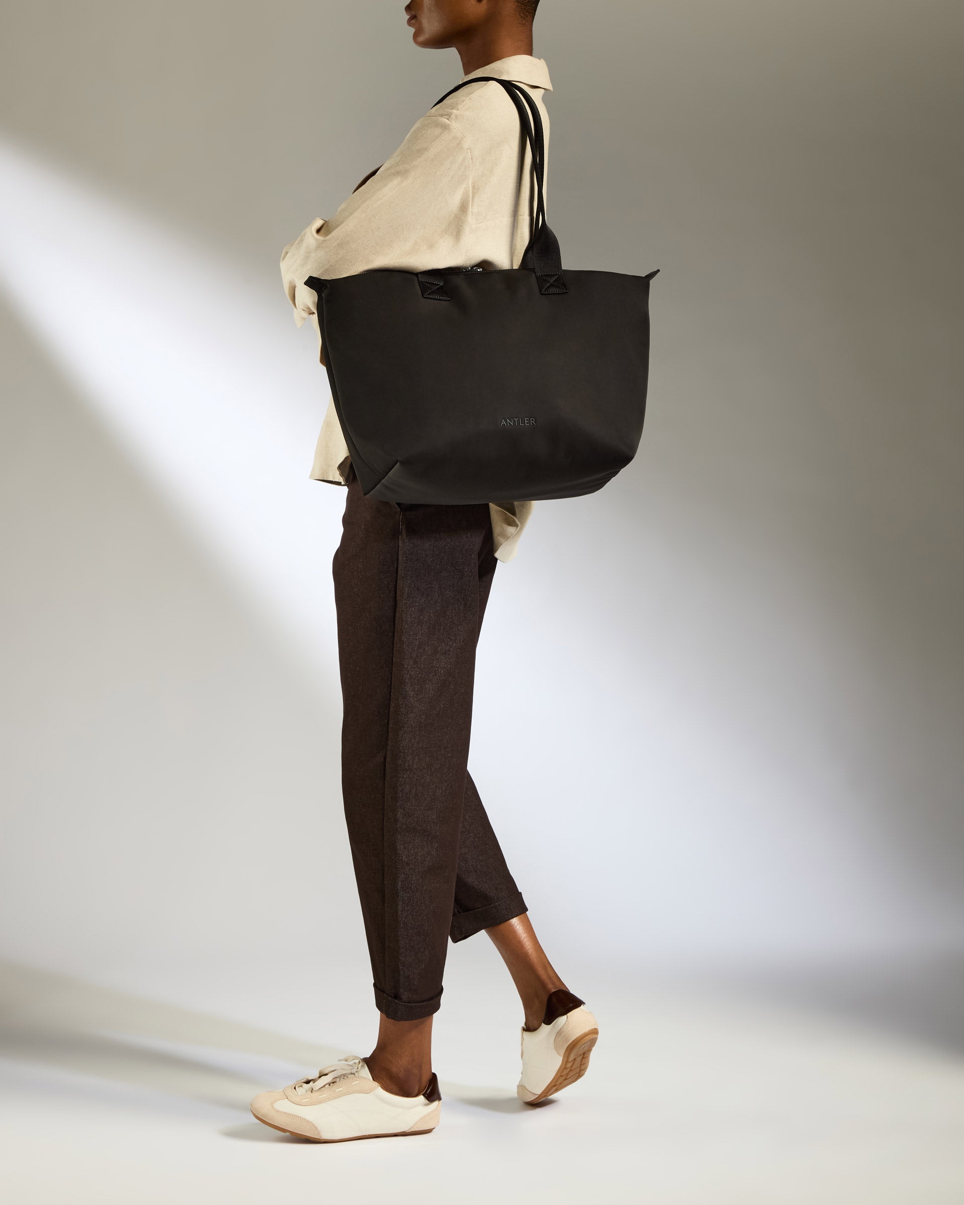 a woman holding a black bag