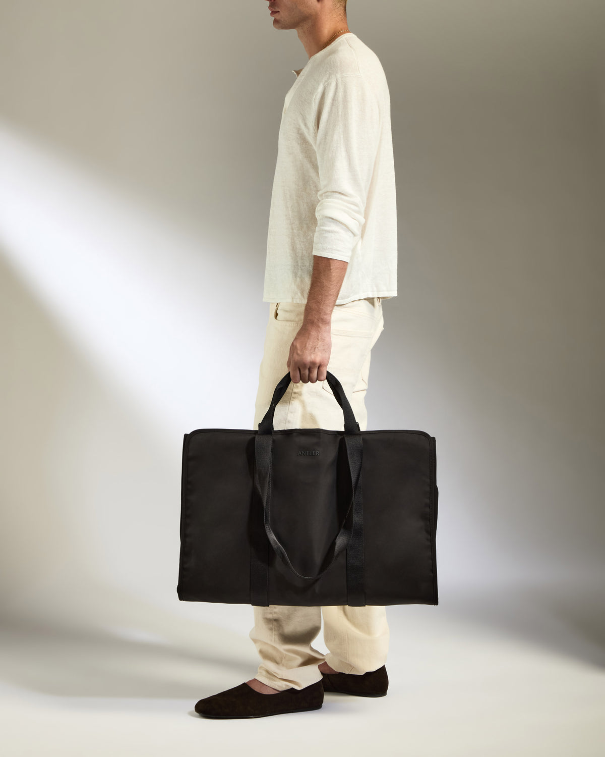 a man holding a black bag