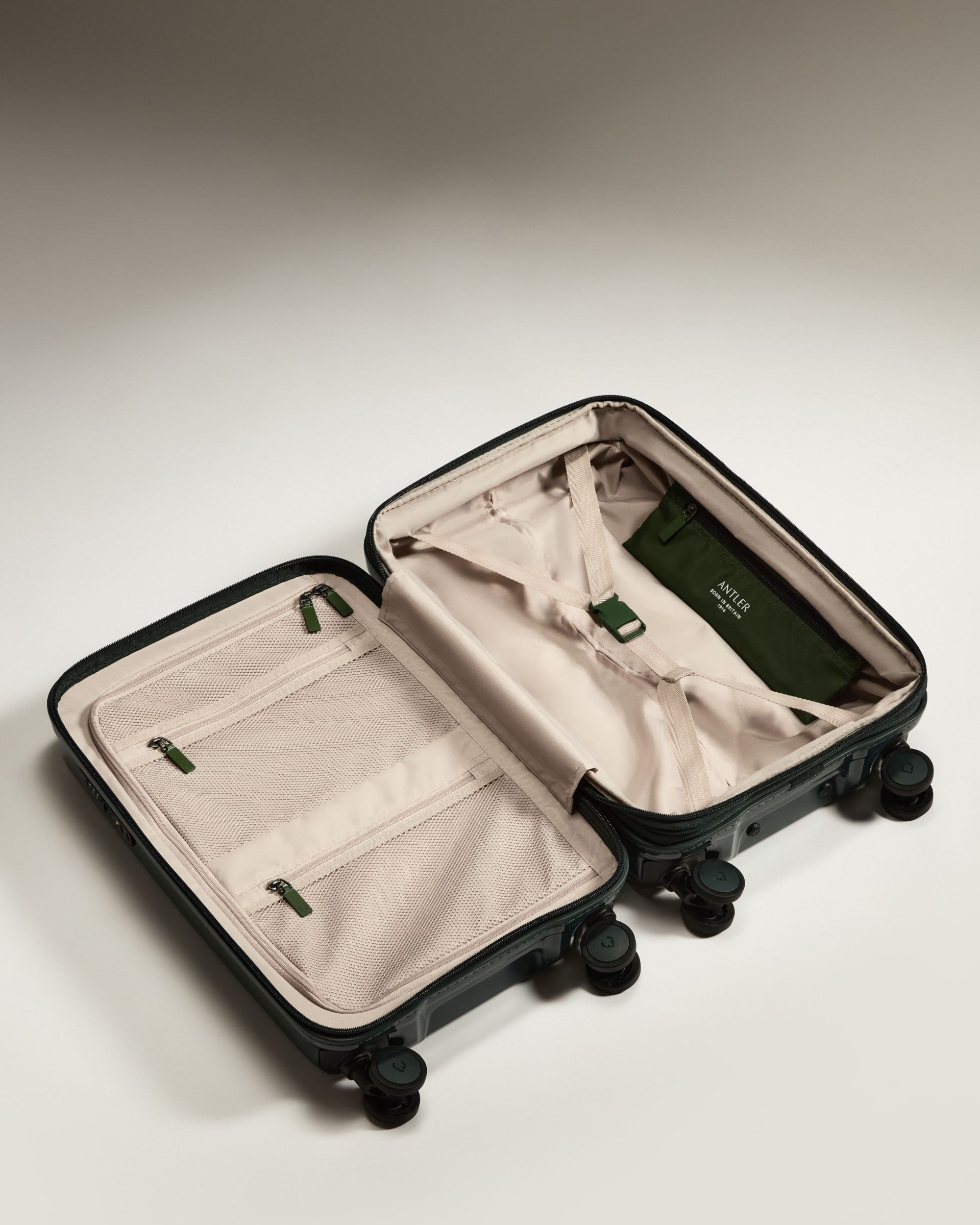 a suitcase with wheels and a green cover
