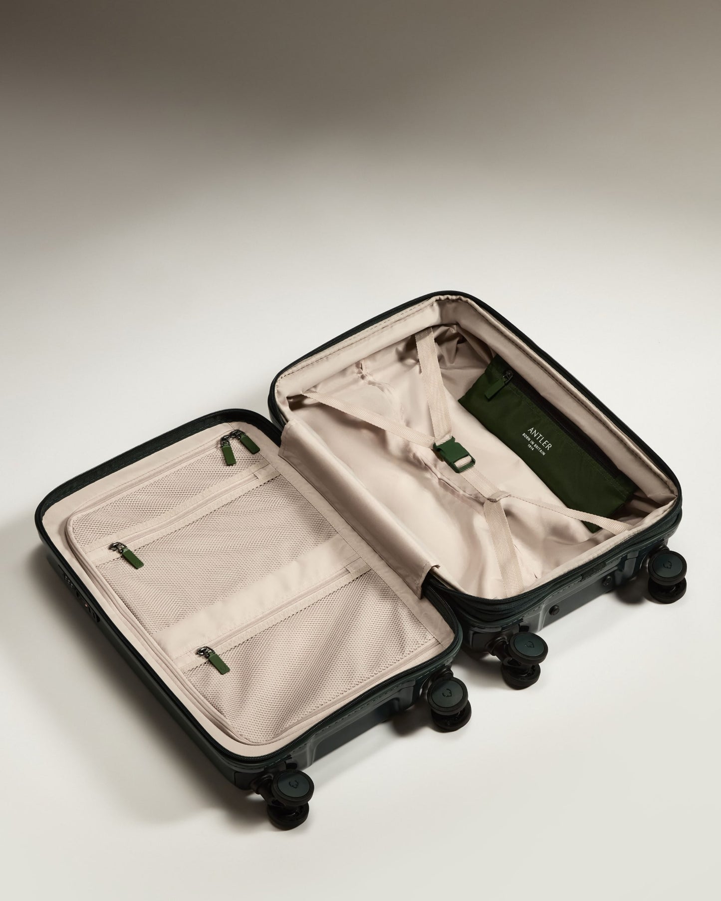 a suitcase with wheels and a green cover