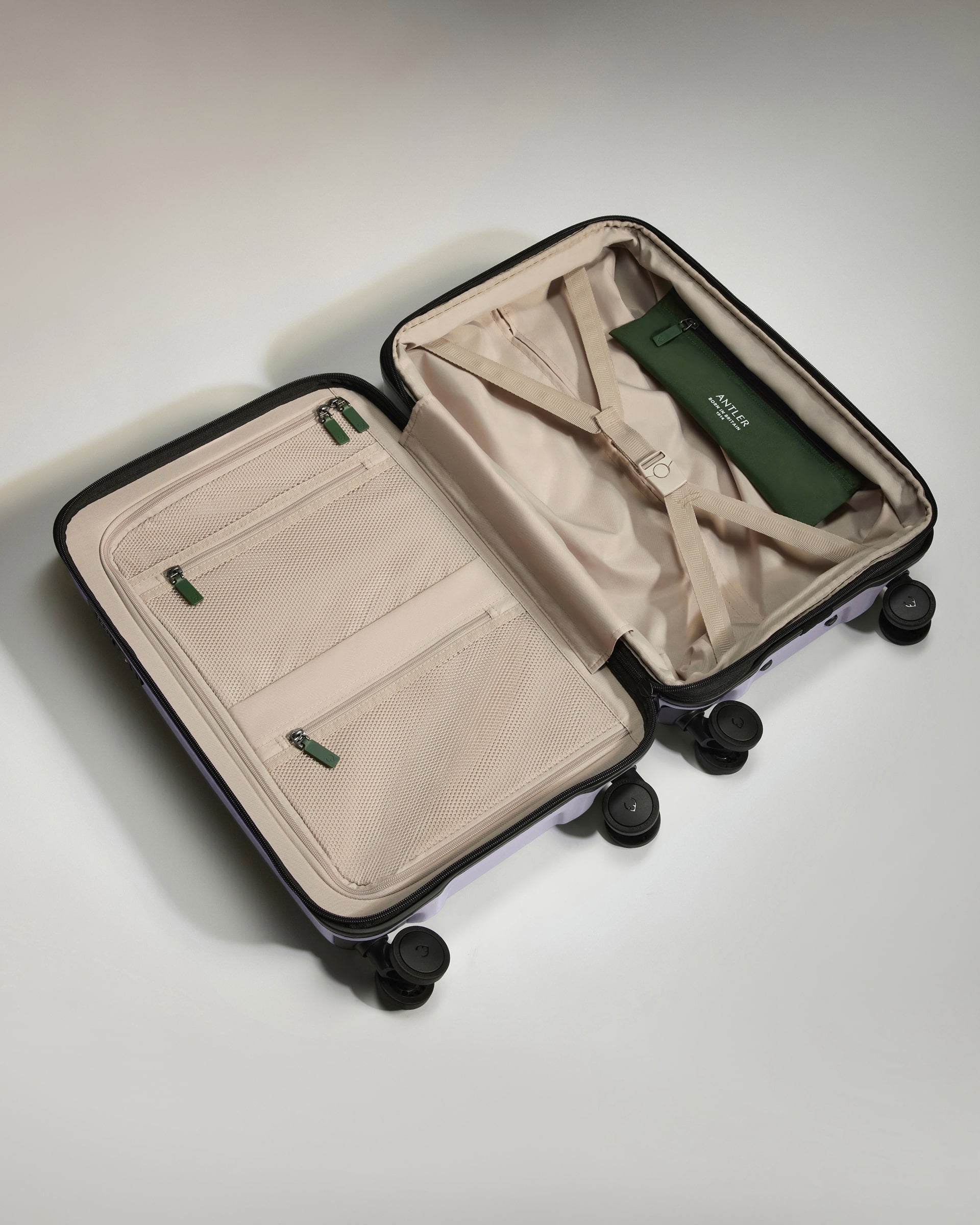 a suitcase with wheels and a green object