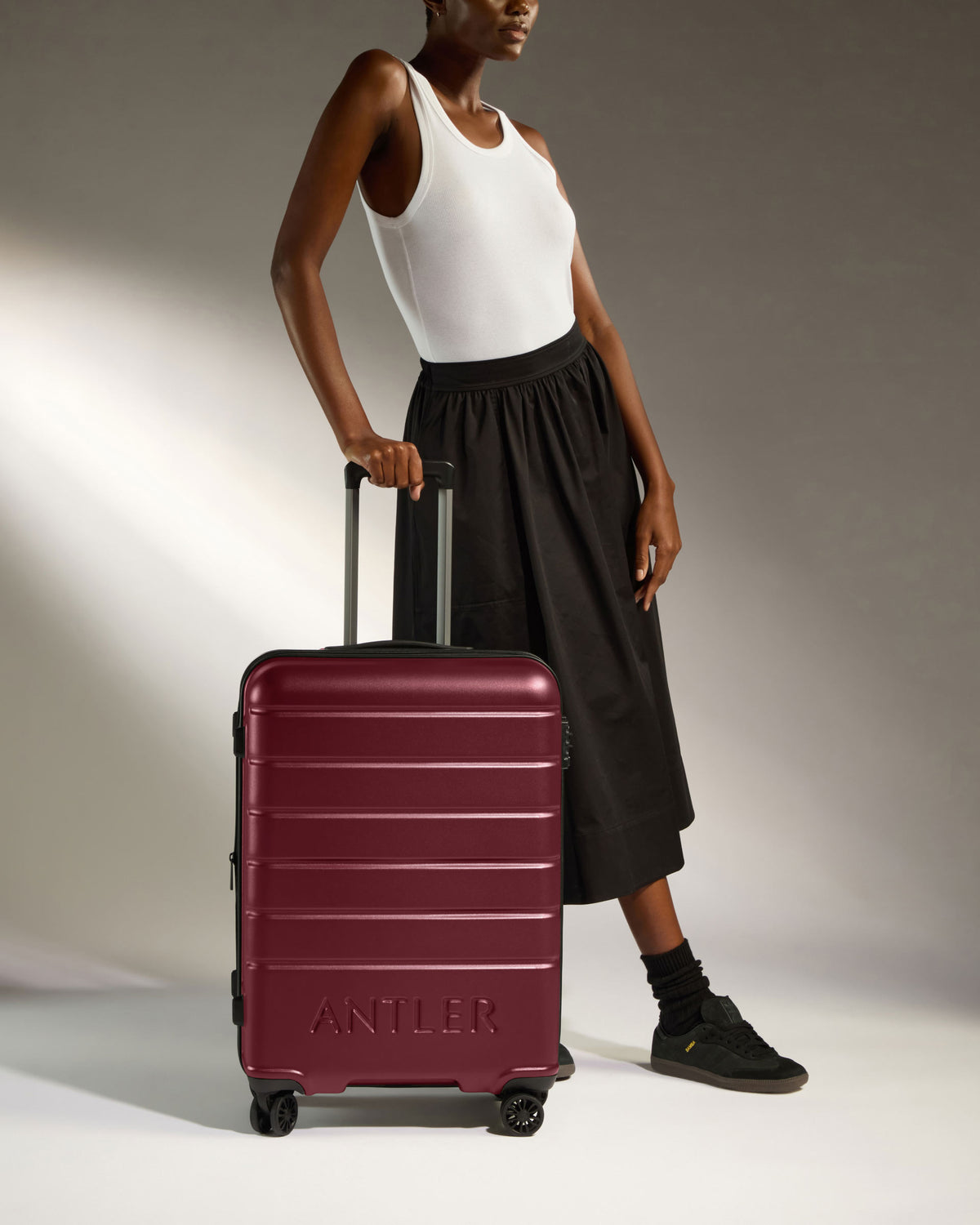 a woman standing next to a suitcase