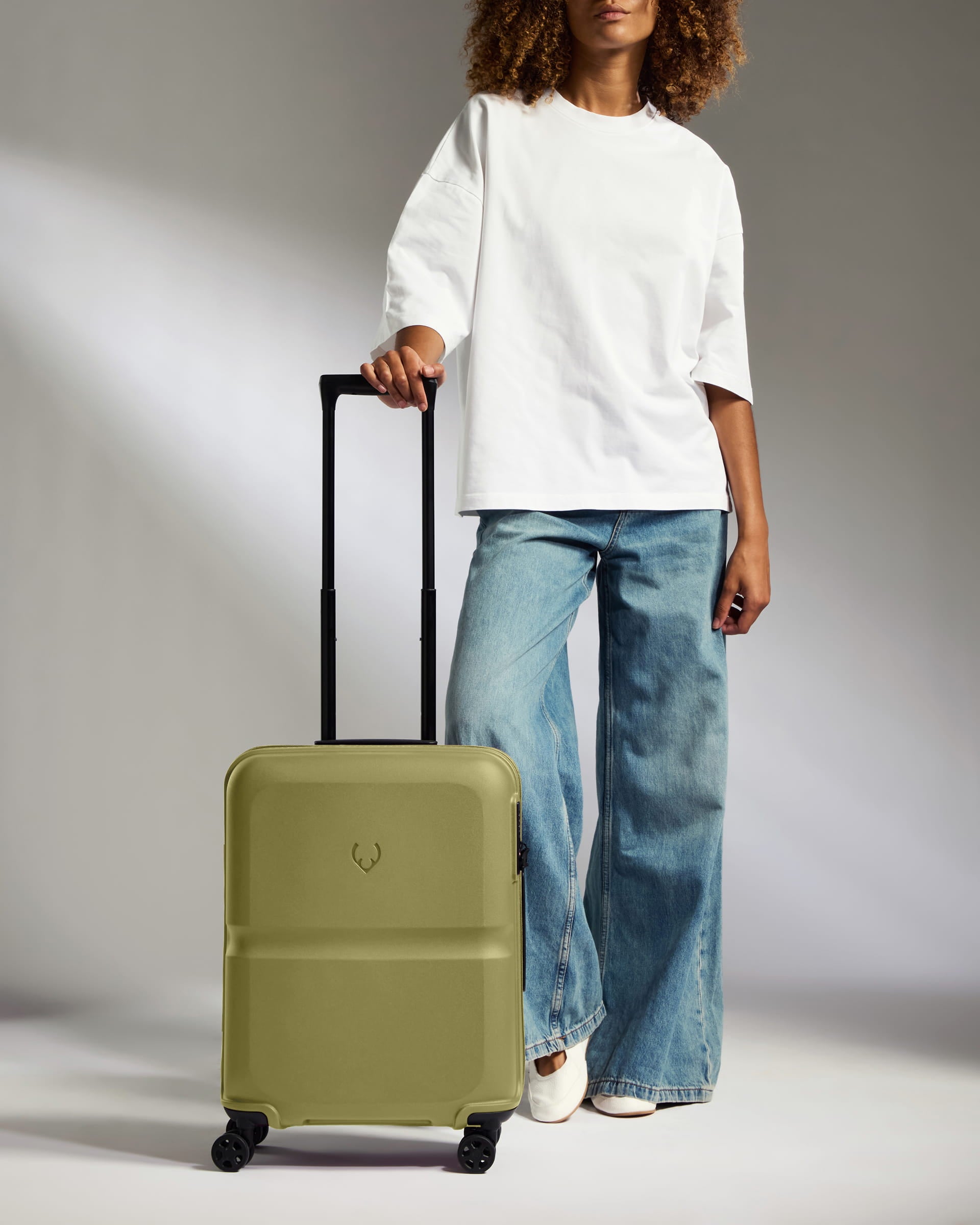 a woman standing with a suitcase