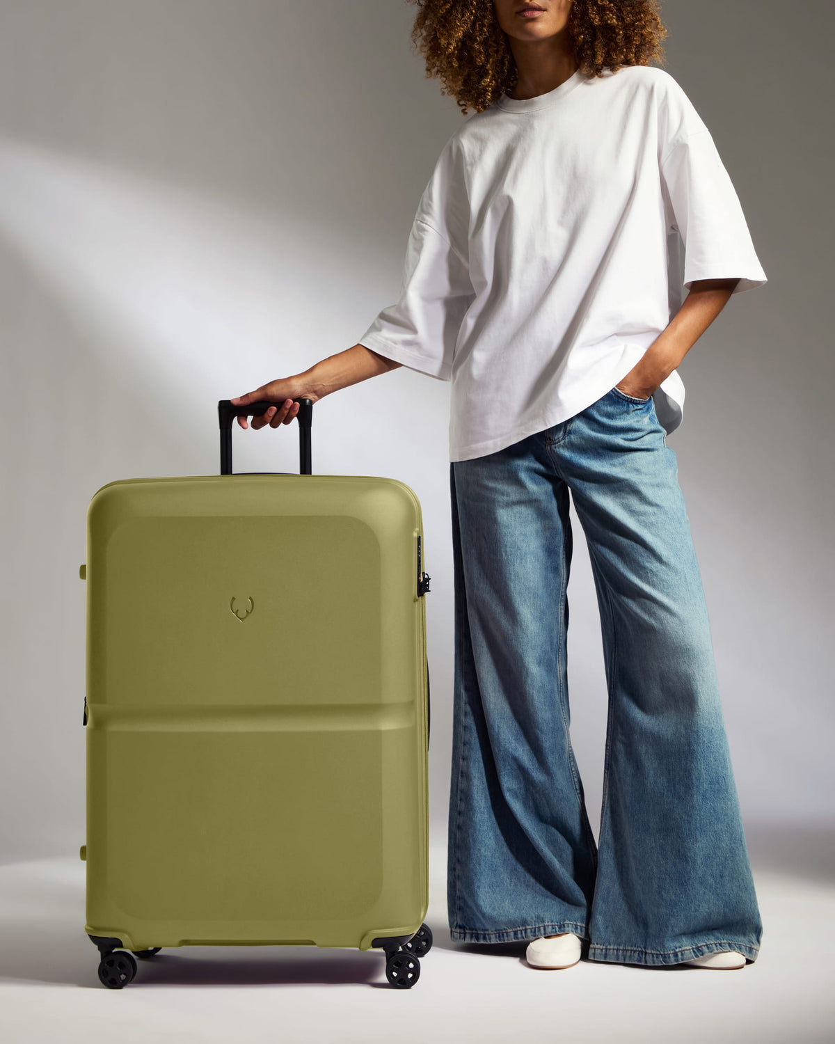a woman standing with a suitcase