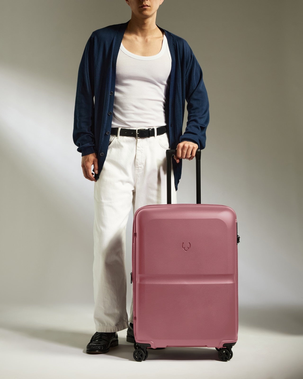 a man standing with a suitcase