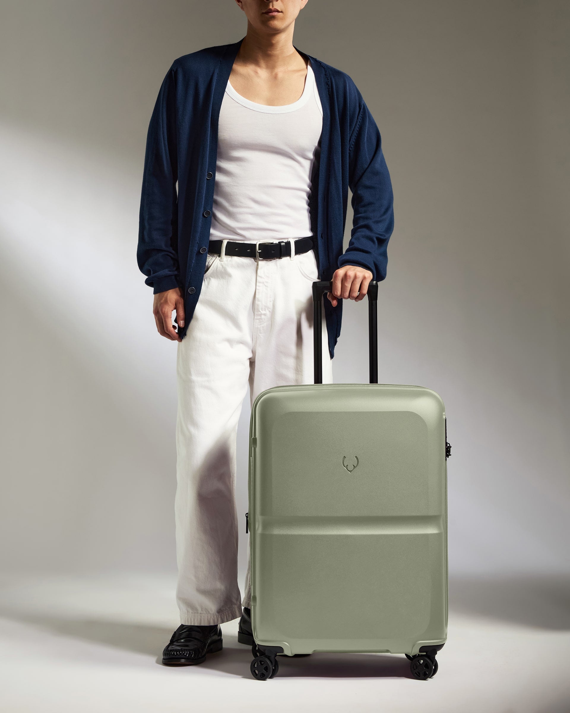 a man standing with a suitcase