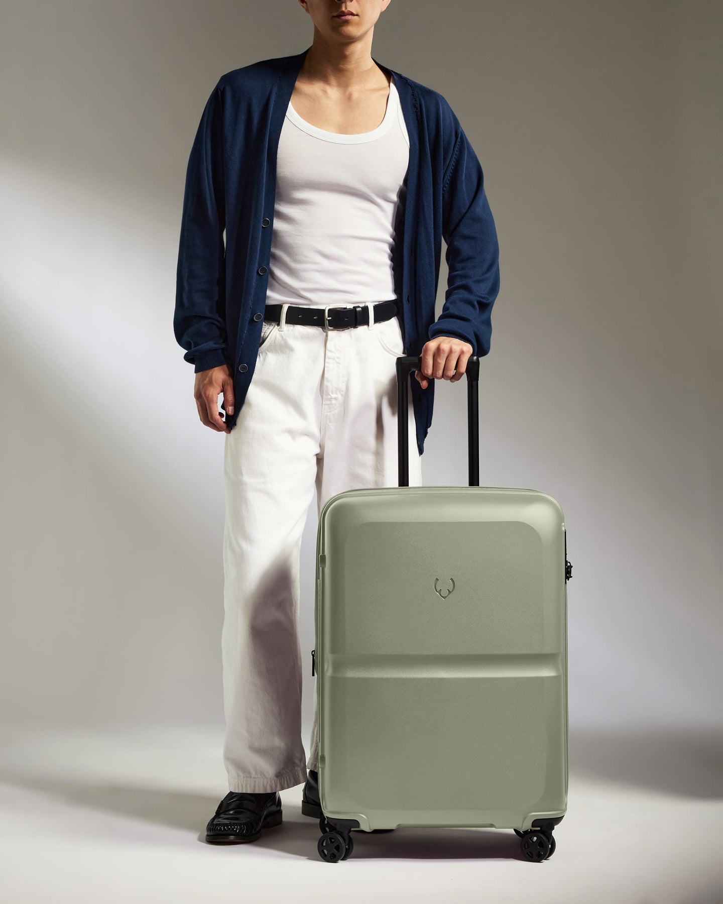 a man standing with a suitcase