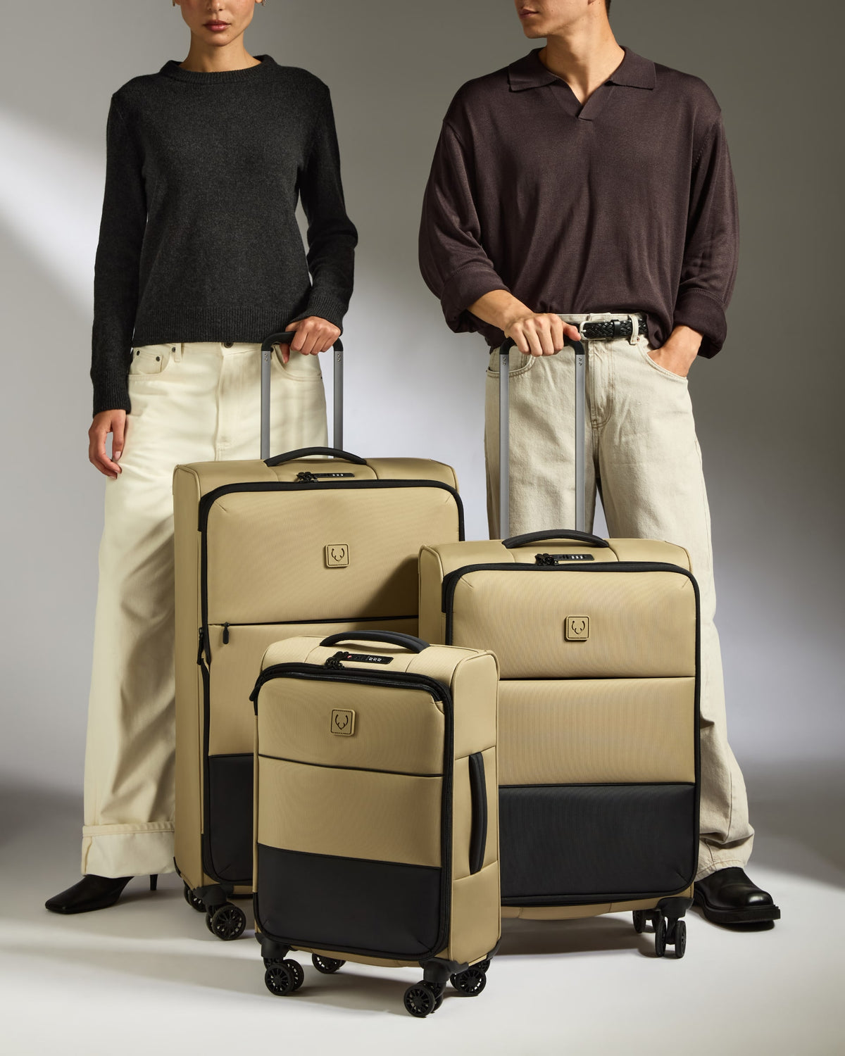 a man and woman standing next to luggage
